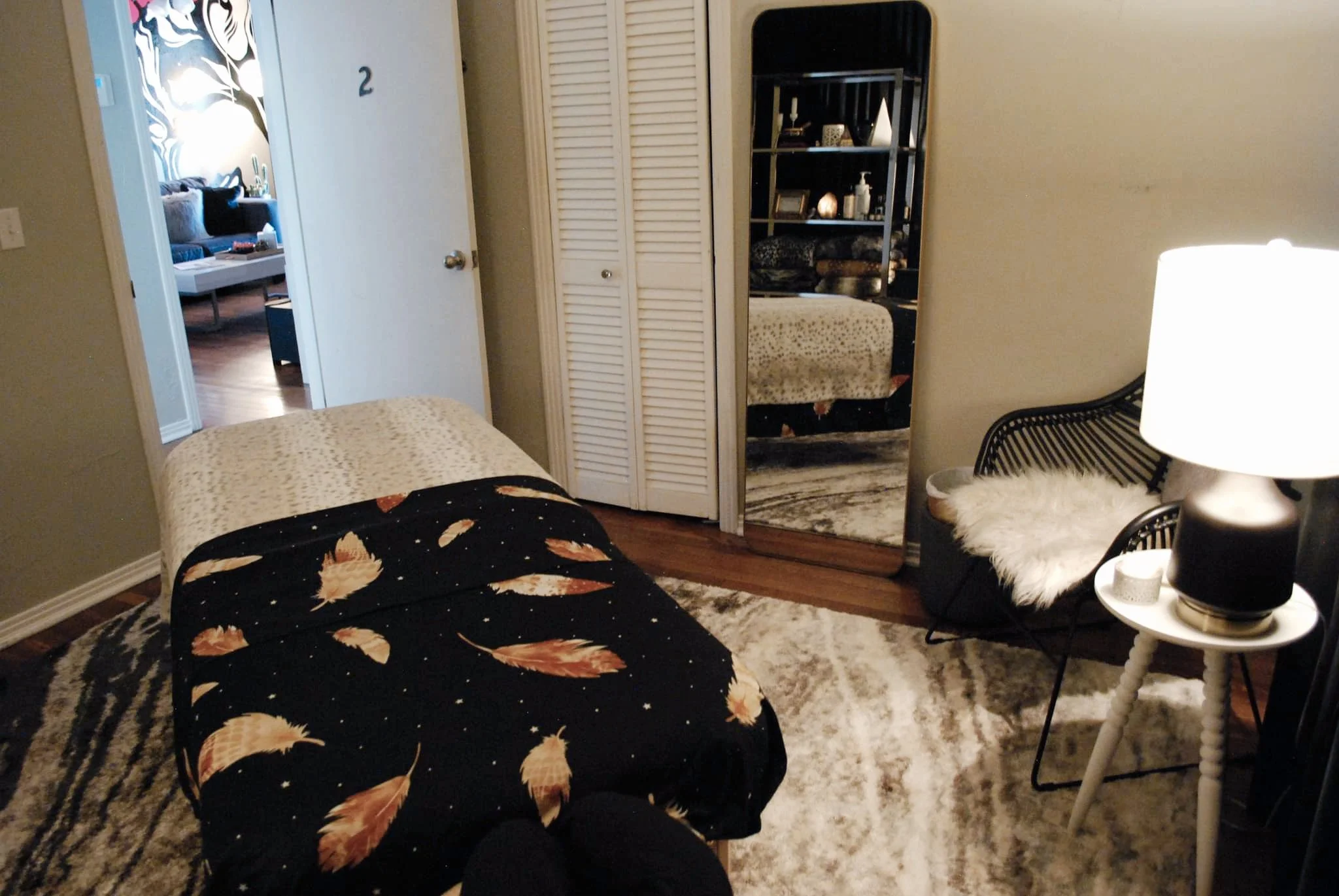 massage room with full length mirror and chair for your belongings