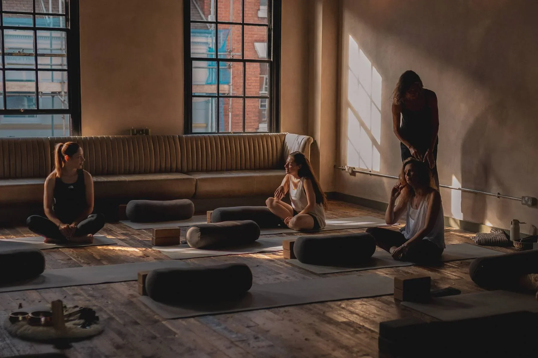 Yoga class at Heist House Studios in Warwick with students practising on mats in a sunlit studio