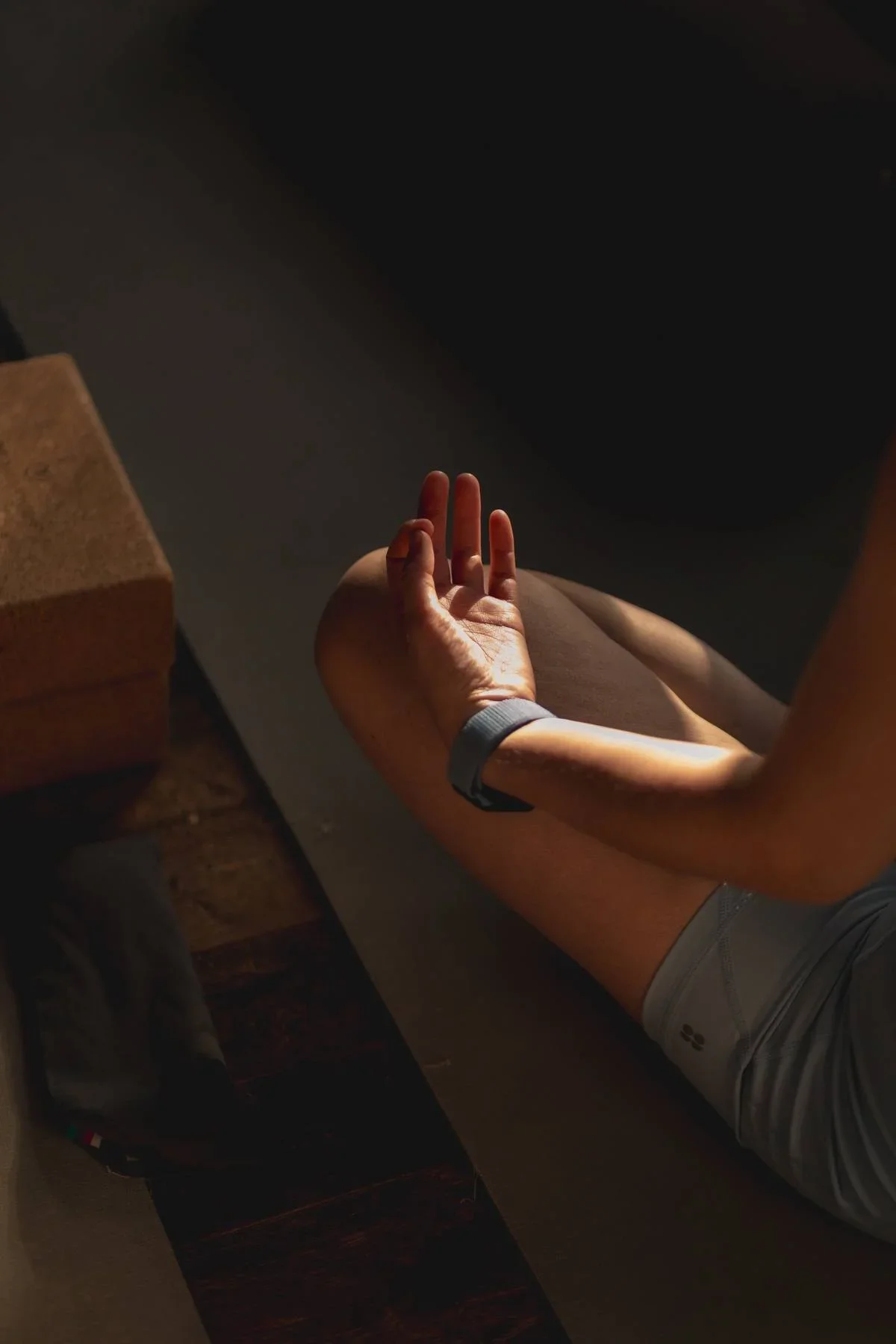 Close-up of a yoga practitioner’s hand resting in a meditation mudra during a gentle yoga class, symbolising calm and mindfulness.
