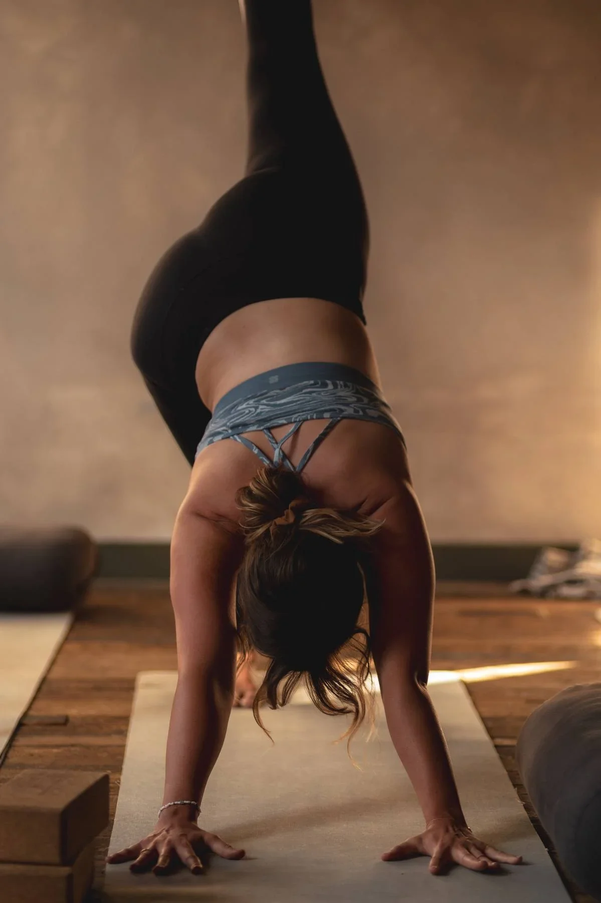 Student practising downward dog pose during Rocket Yoga class at Warwick yoga studio