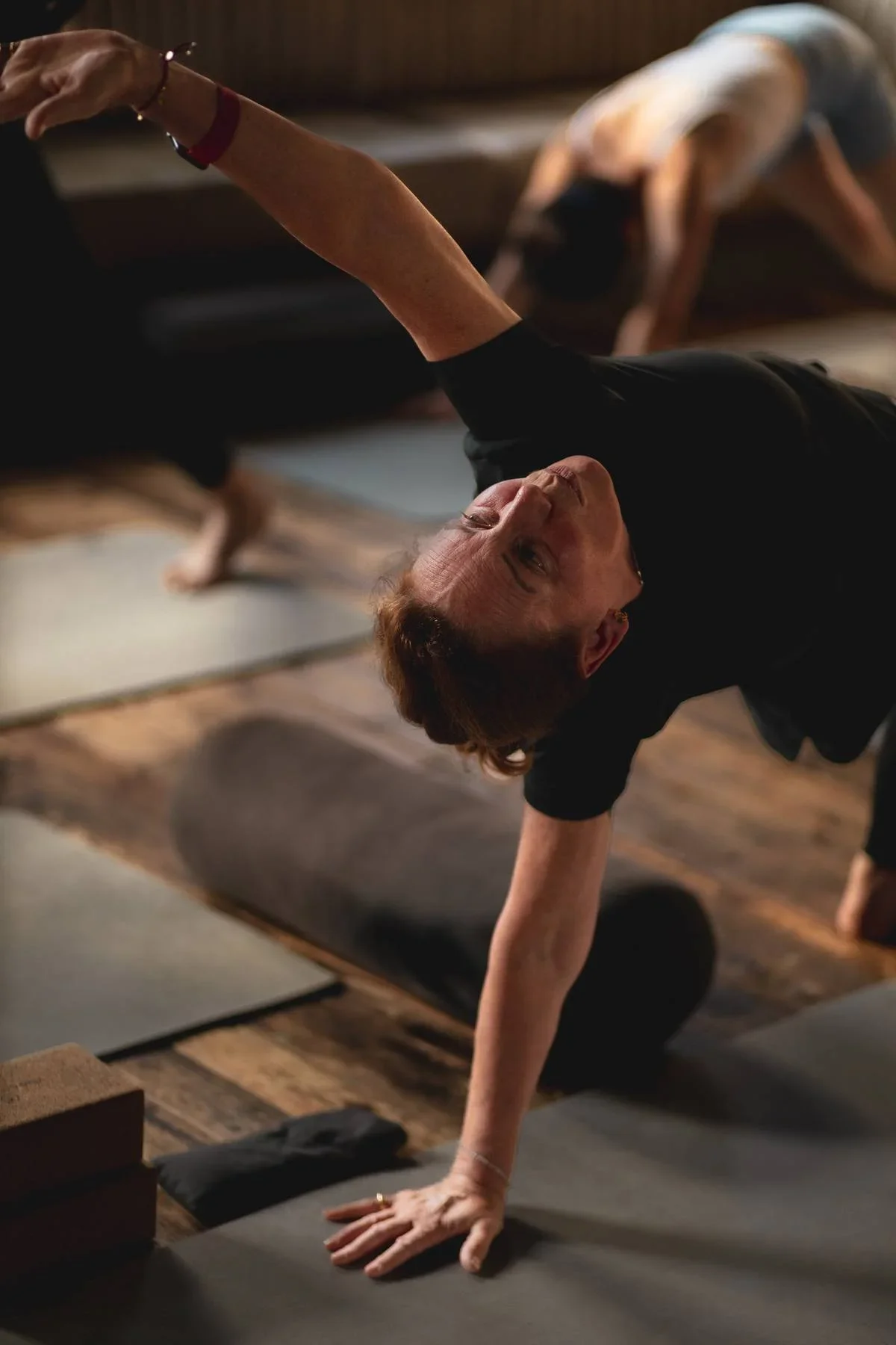 Student practising side plank variation during Rocket Yoga class in Warwick