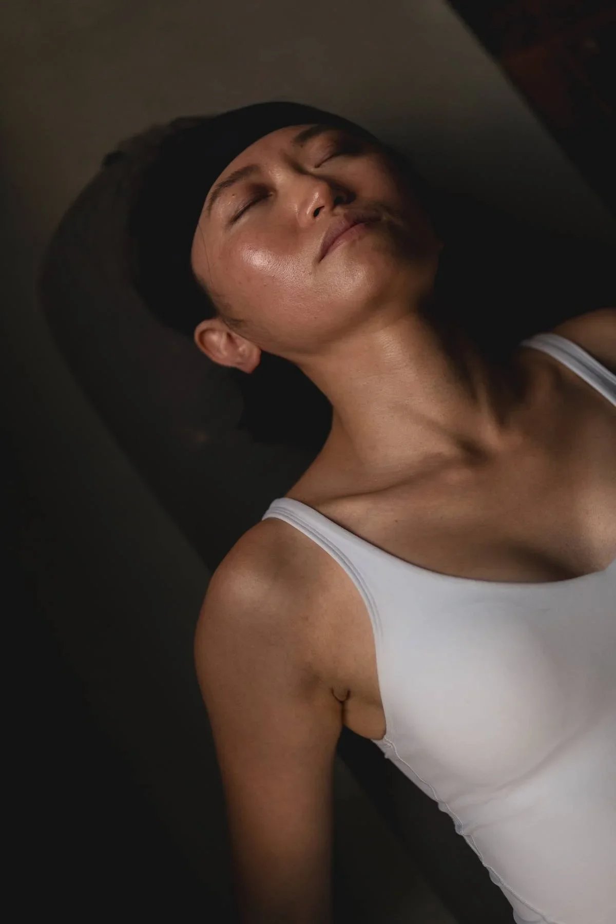 Person resting with eyes closed during a gentle beginners yoga relaxation at Heist House Studios in Warwick