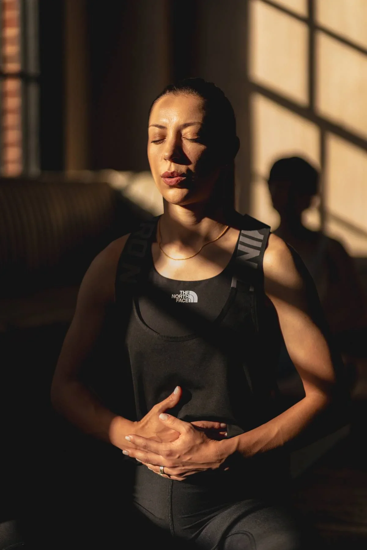 Beginner yoga student practising mindful breathing during a yoga class in Warwick.