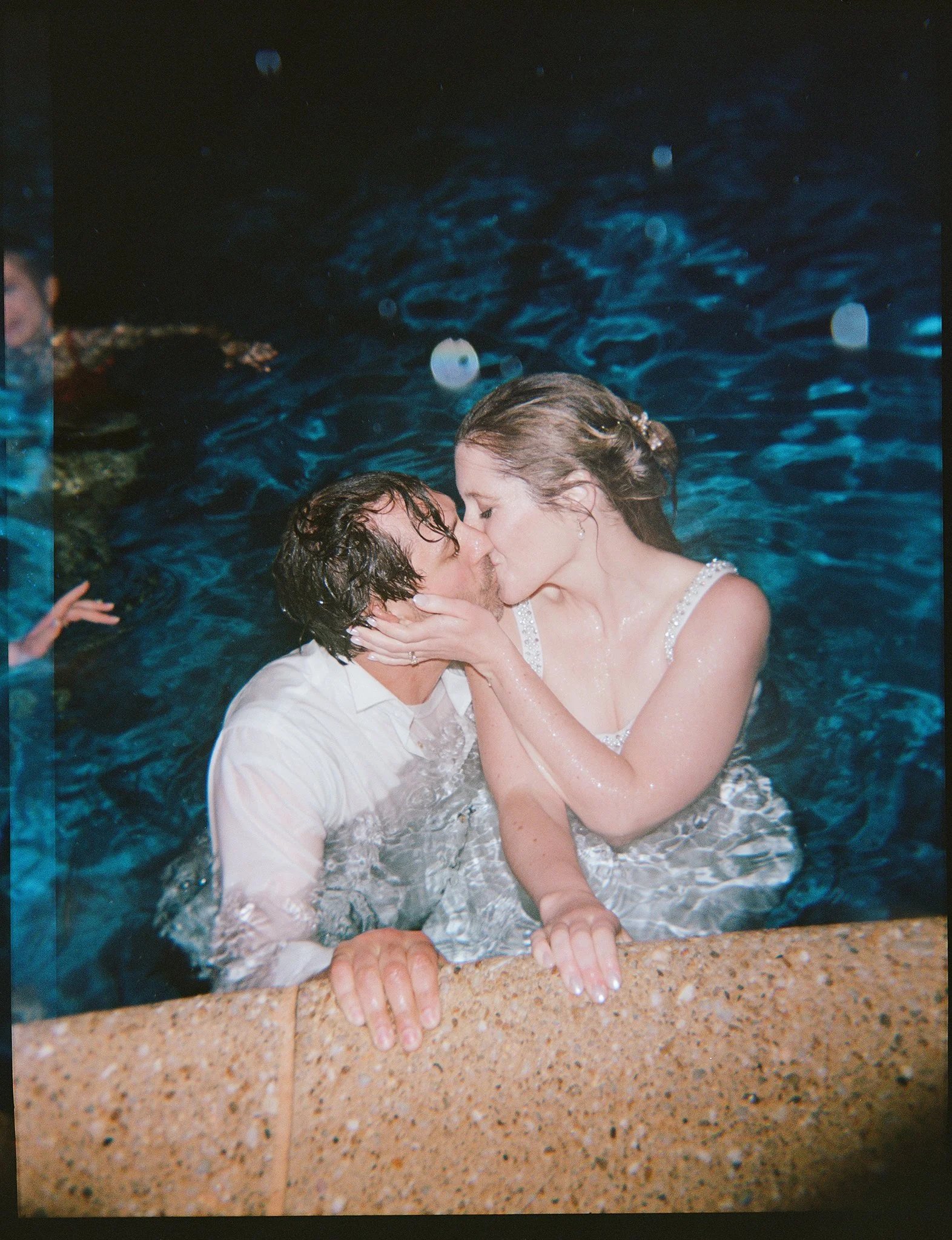 bride and groom in pool