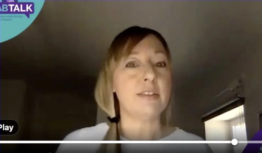 Scientist Melissa Sterry speaking in a video call, with a light complexion and brown hair, wearing a light-colored shirt. The screen has a play button and a progress bar, indicating video playback. There is a "LAB TALK" logo in the top left corner.