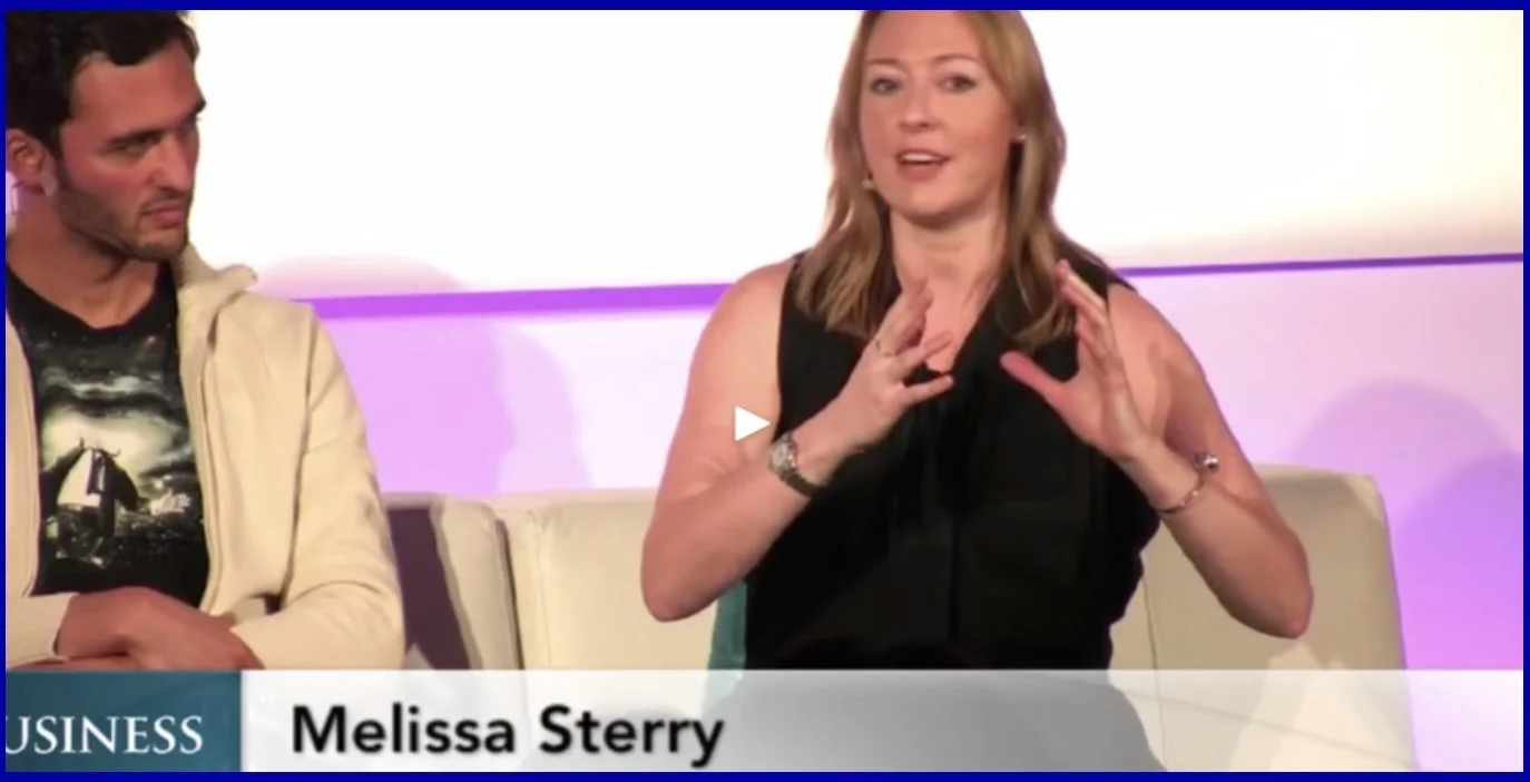 Futurists Melissa Sterry and Jason Silva sitting on a panel discussion stage, with a woman gesturing while speaking and a man listening attentively. The name "Melissa Sterry" appears on the lower-third graphic.