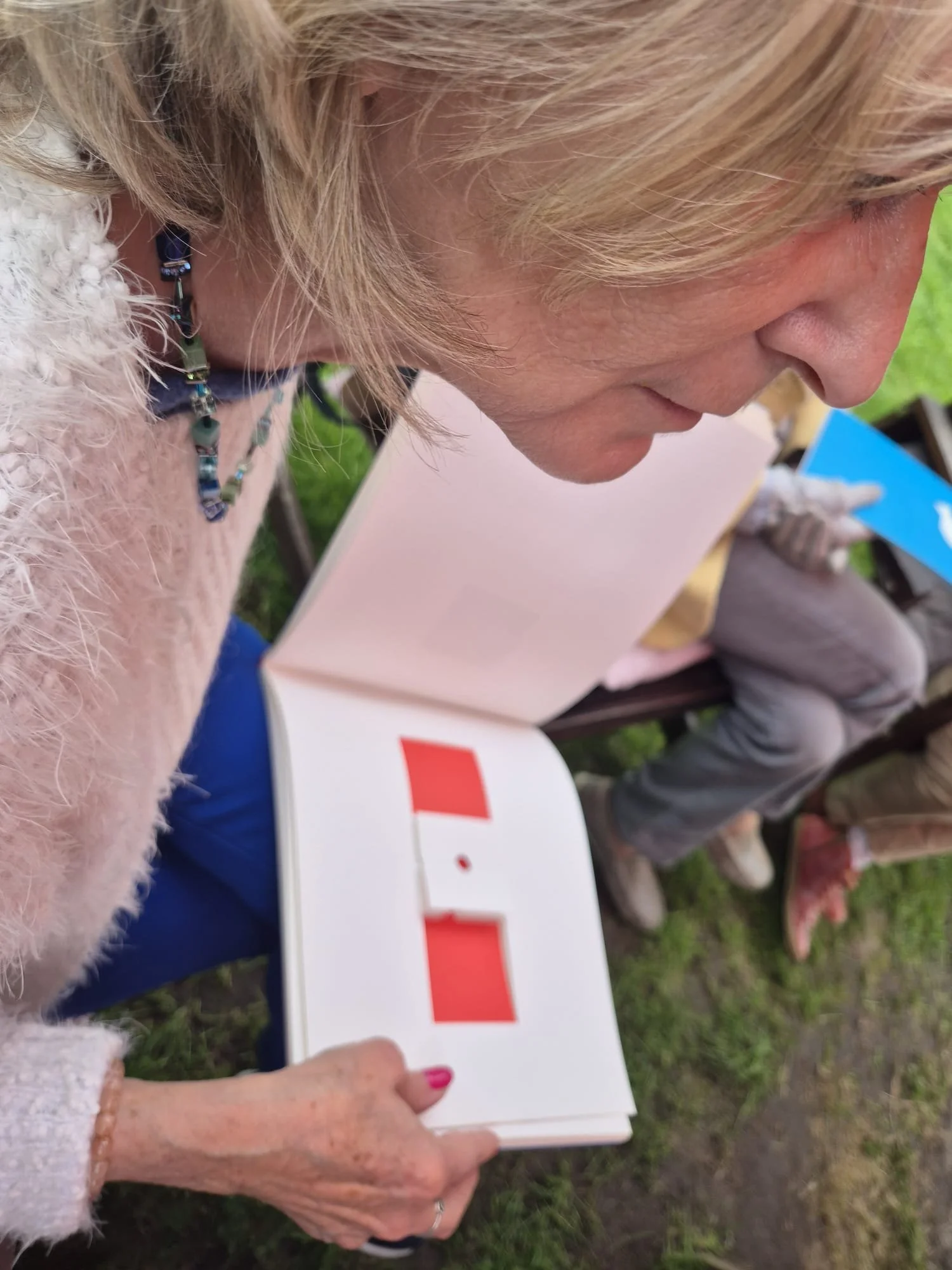 A woman looking over an open book