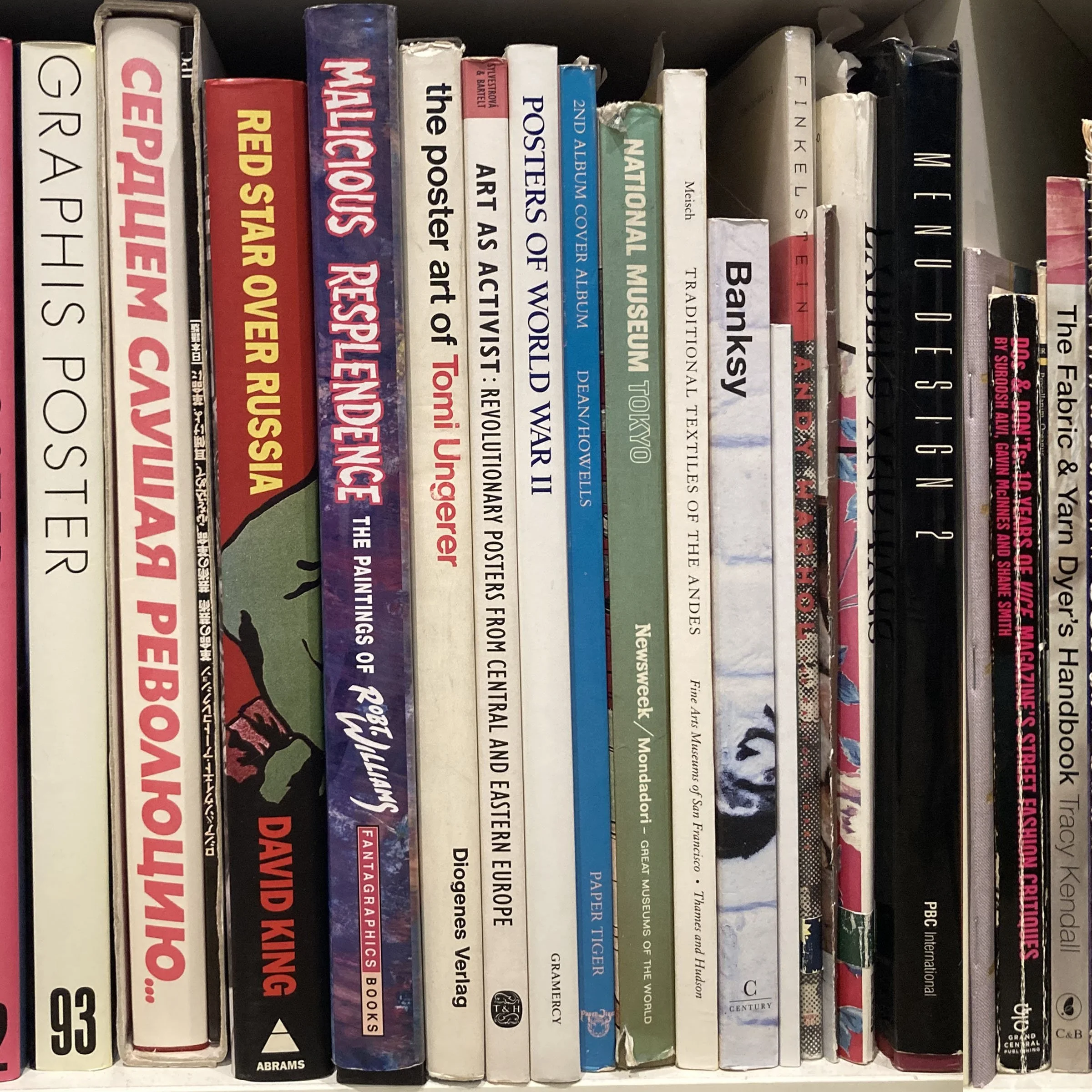 Close-up of a shelf filled with books, mostly art, design, and history books, with some showing visible titles and authors.