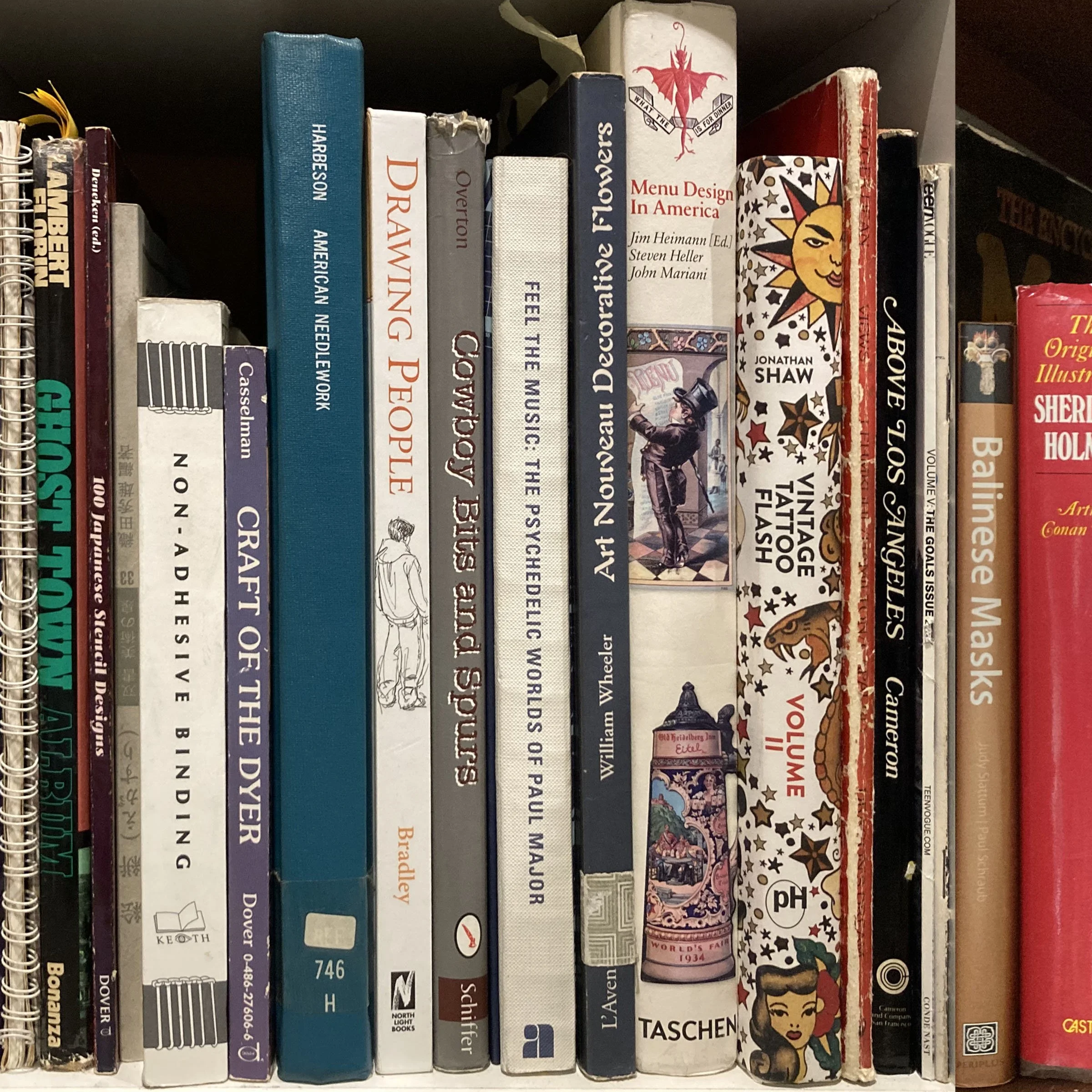 A row of books on a shelf, with various colors, sizes, and titles related to design, art, and culture.