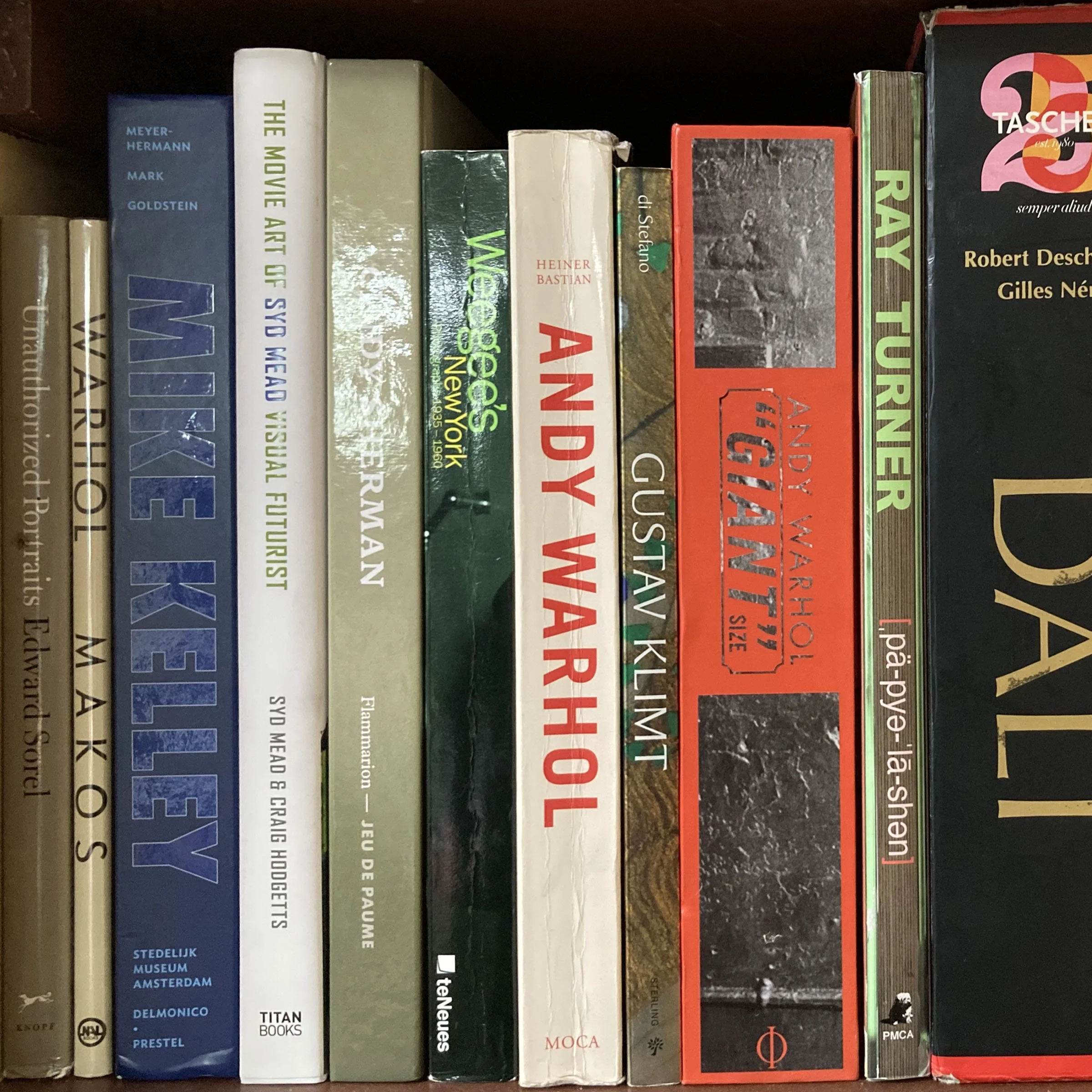 A row of books on a bookshelf, including titles related to art, museums, and history.