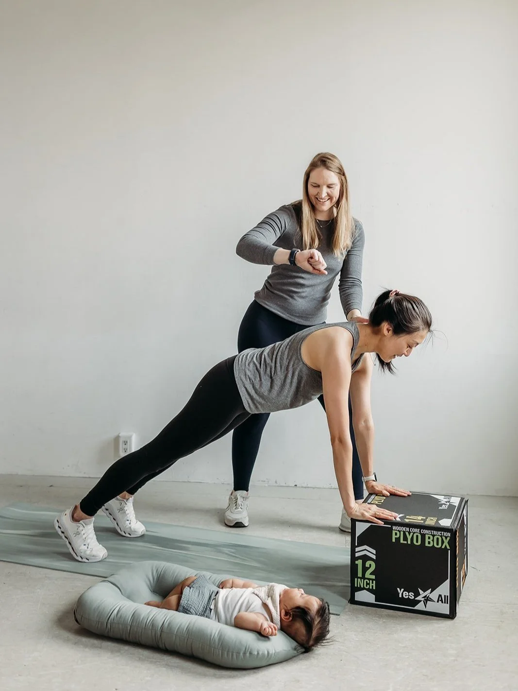 A pelvic floor PT supports new mom during strength training session at Foundations Pelvic Health in Boston, Massachusetts.