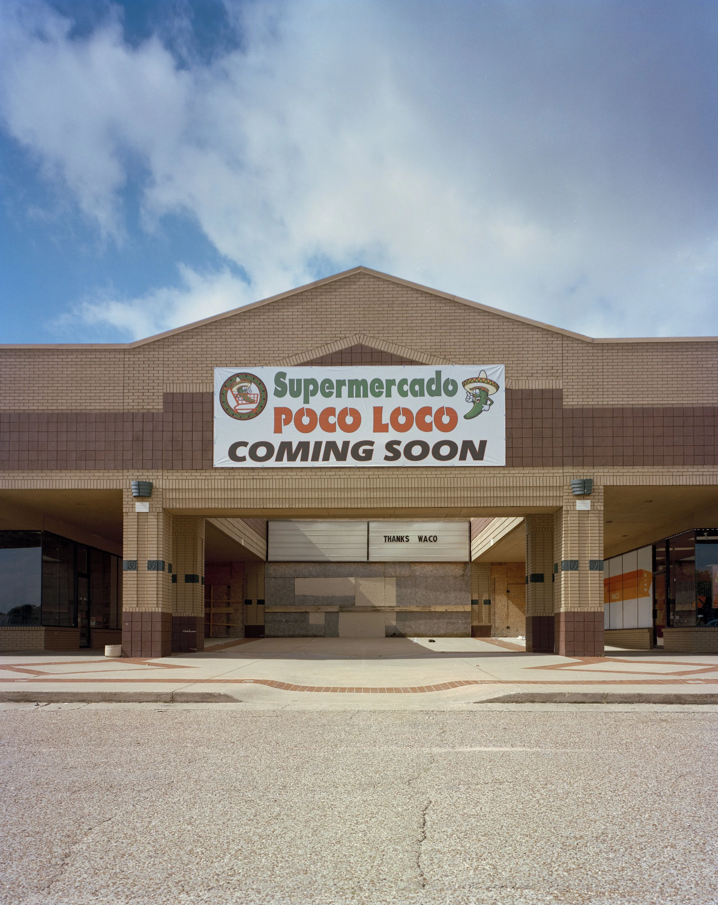 Empty storefront with a sign that reads 'Supermercado Poco Loco Coming Soon' and a message that says 'Thanks Waco' in the background.