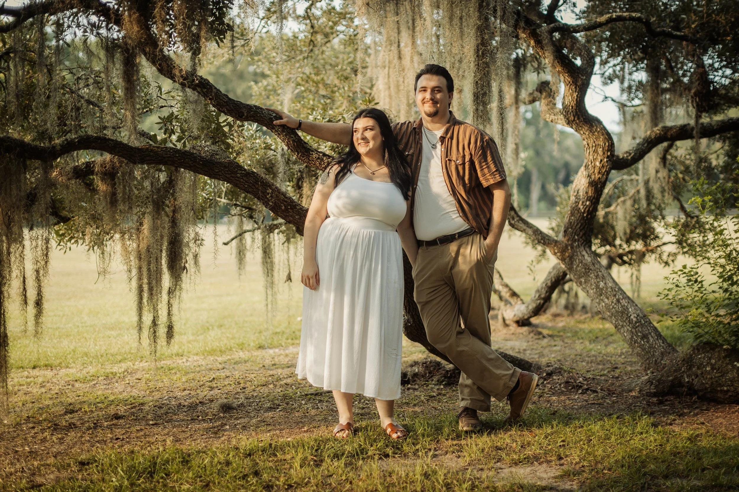Engaged couple under live oaks at Magnolia Plantation, Charleston