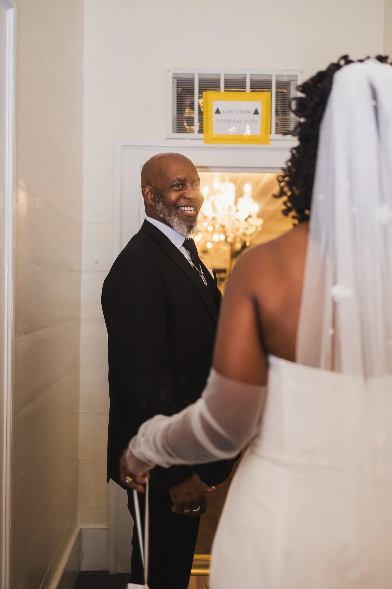 Ashlee and Chris wedding at Southern Oaks Event Venue in Gilbert, South Carolina: father of the bride smiling as he greets the bride.
