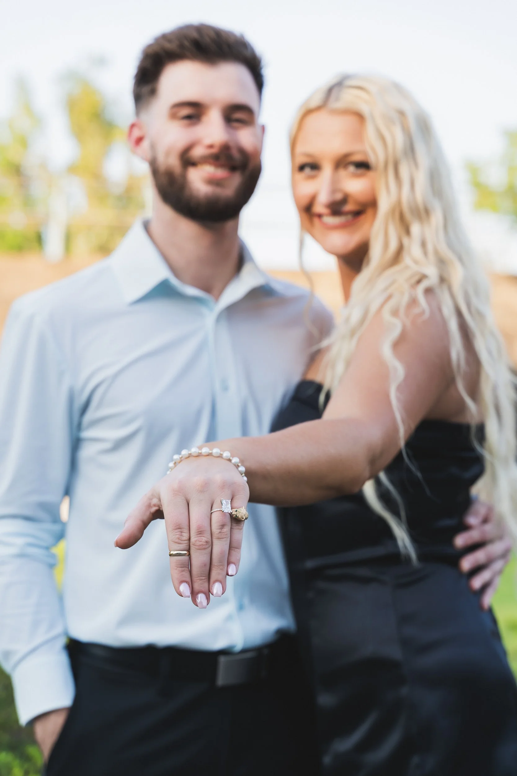 Newly engaged couple showing the ring
