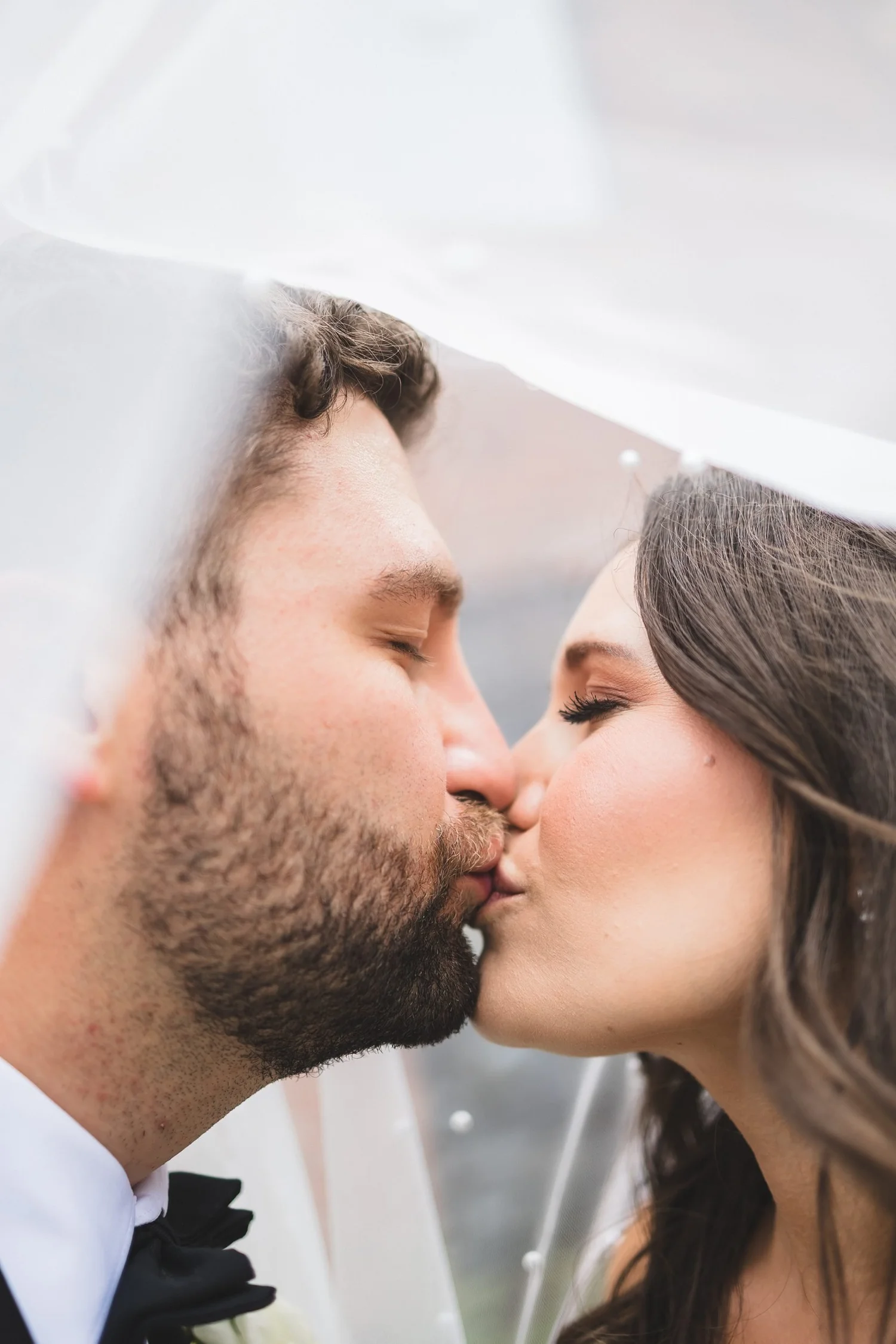 Madison and Derek kiss under her veil on their Huguenot Mill wedding day in Greenville, South Carolina.