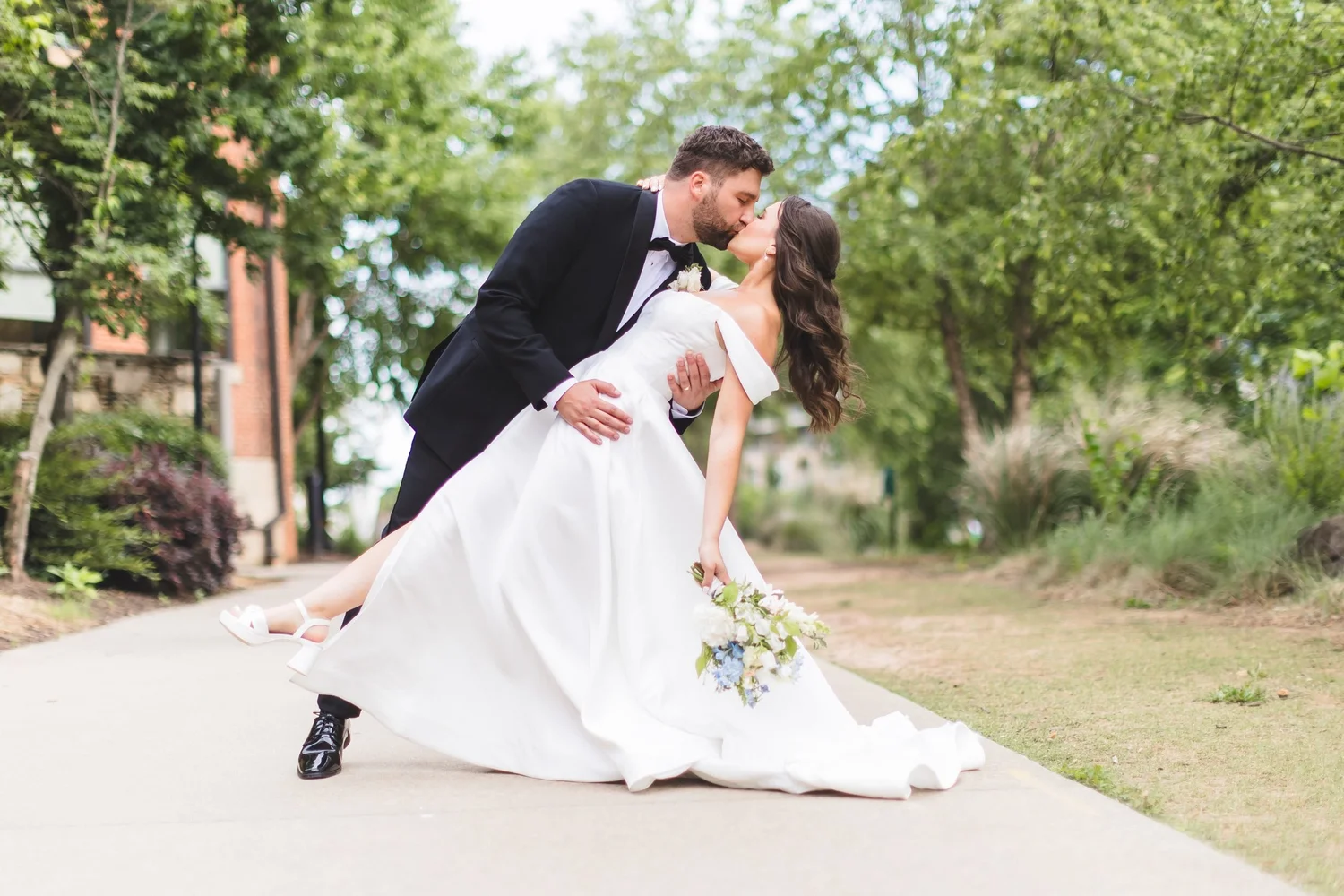 Madison and Derek share a dip kiss on their wedding day in downtown Greenville, South Carolina.