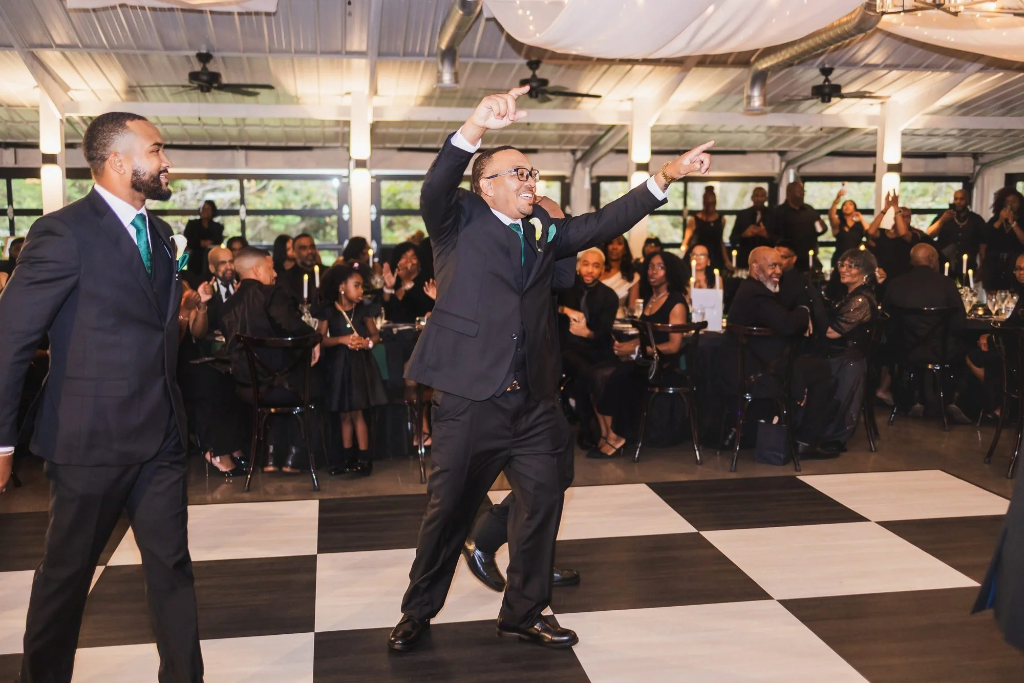 Ashlee and Chris wedding at Southern Oaks Event Venue in Gilbert, South Carolina: wedding party entrance in the reception hall with a checkered dance floor.