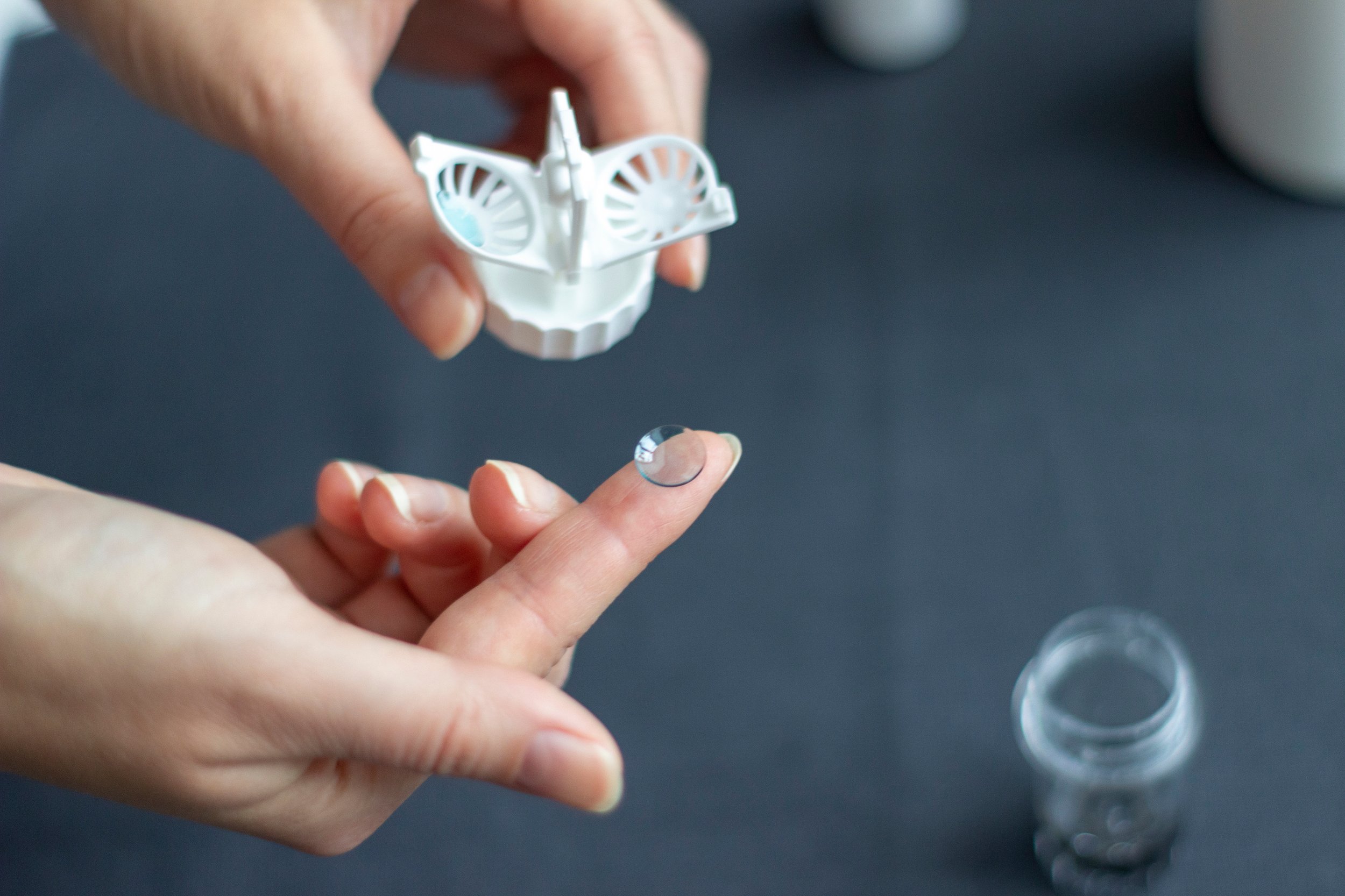 a person holding a hard contact lens for keratoconus