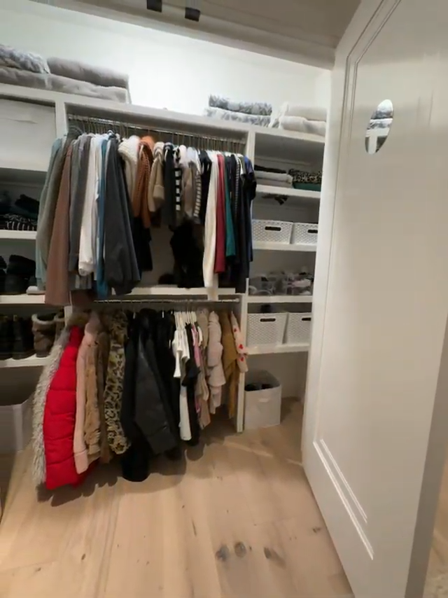 Closet space with hanging clothes, shelves, and storage baskets. Home Organizing in Bedford, MA