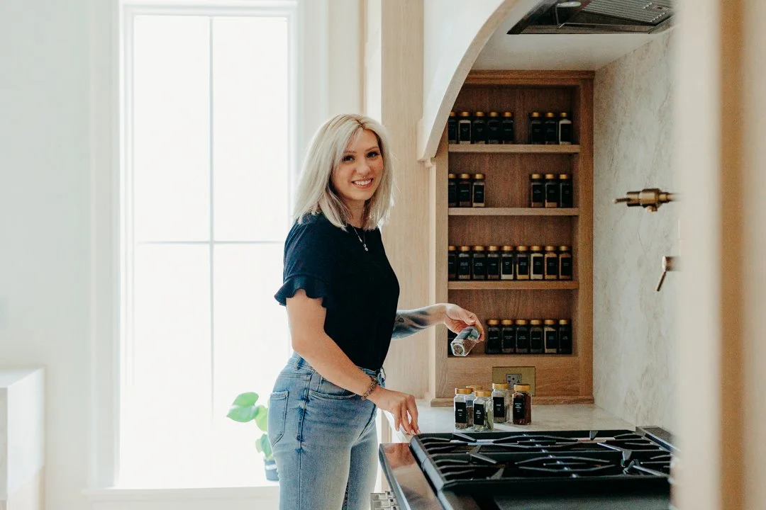 Kitchen drawer organized with labeled spice containers and dividers during decluttering services focused on cabinet organization.