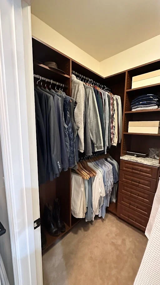 Closet with hanging clothes, folded clothes on shelves, and shoes on the floor.