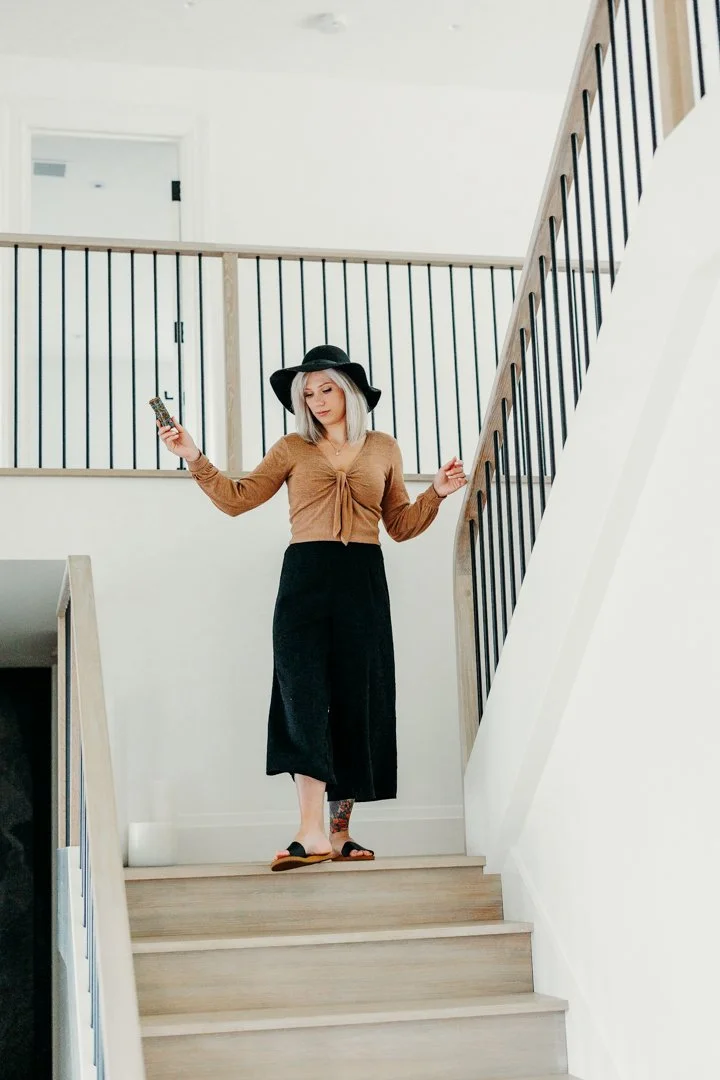 Korinna, feng shui organizer massachusetts, conducting a home energy assessment on a staircase to evaluate flow, movement, and spatial balance