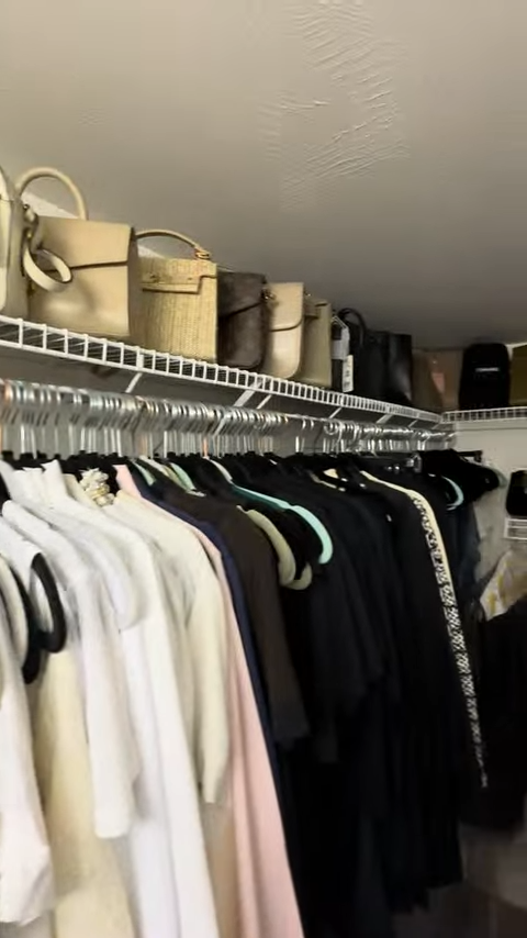 Closet shelf with handbags on top and shirts hanging below