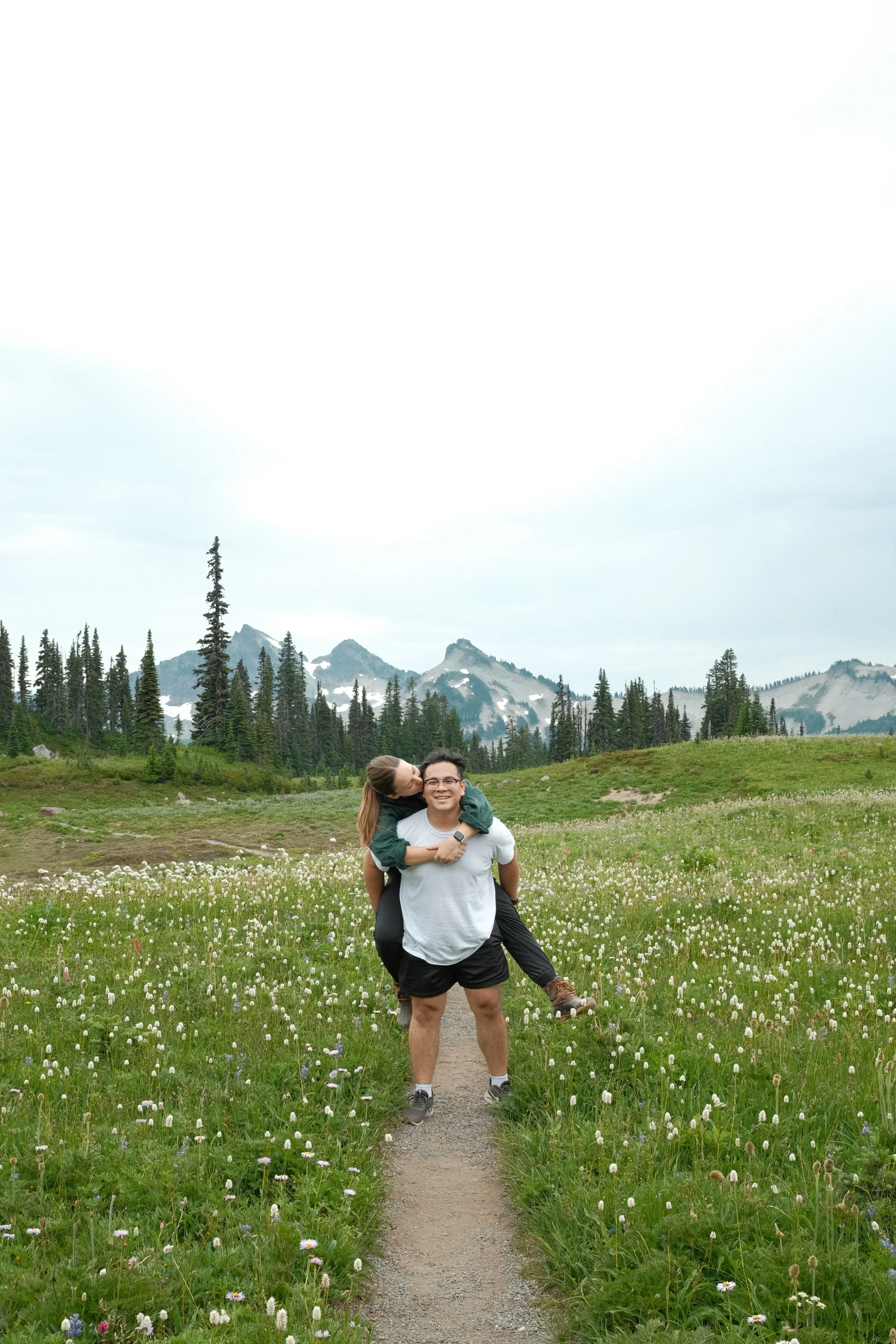 Michael and sarah on a trail in front of mount rainier
