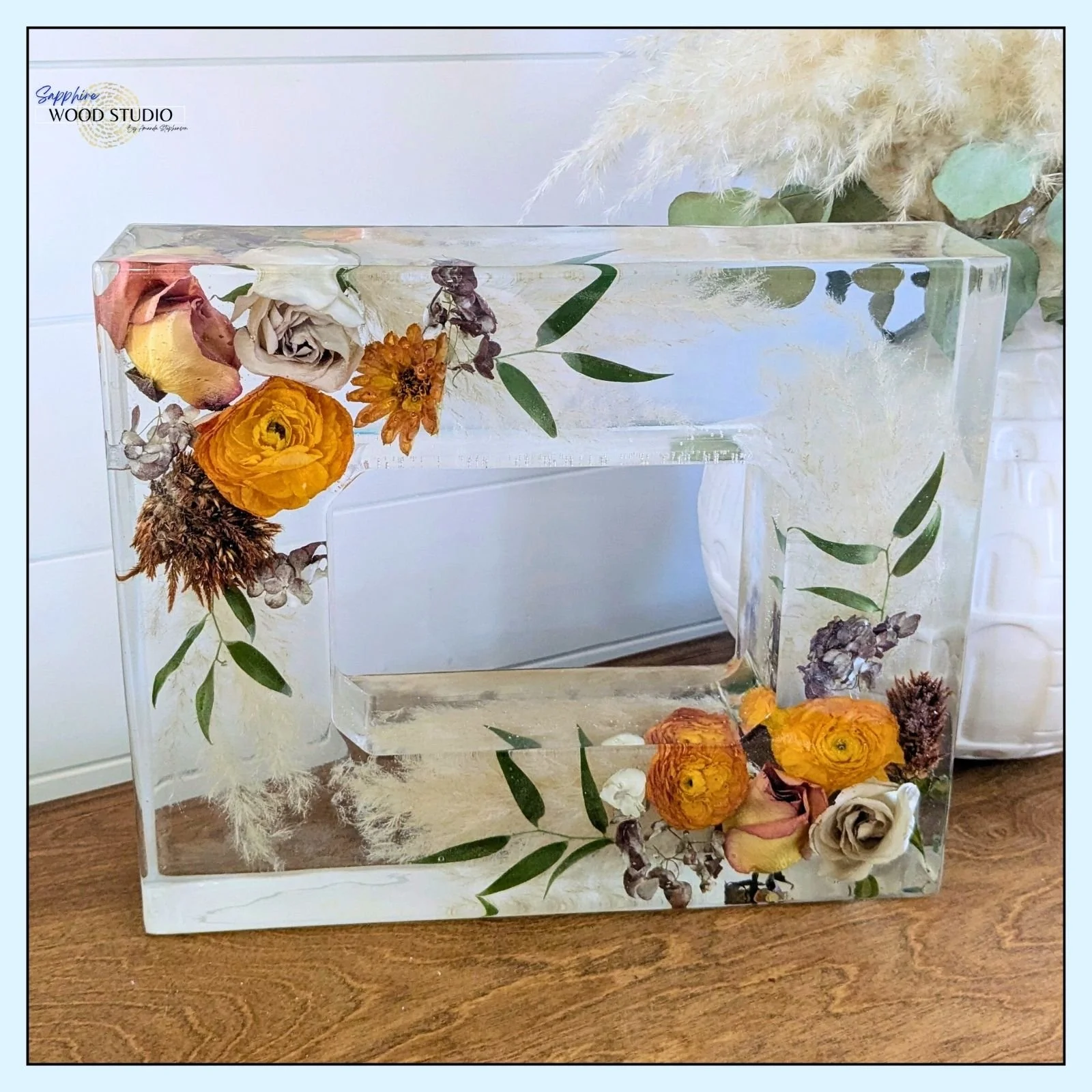 Well hello beautiful! 
3-inch thick resin photo frame made with a very special bridal bouquet. 

If you look real hard you'll see there is more than just flowers. I've made several of these and each one is always special.

It's always an honor to pre