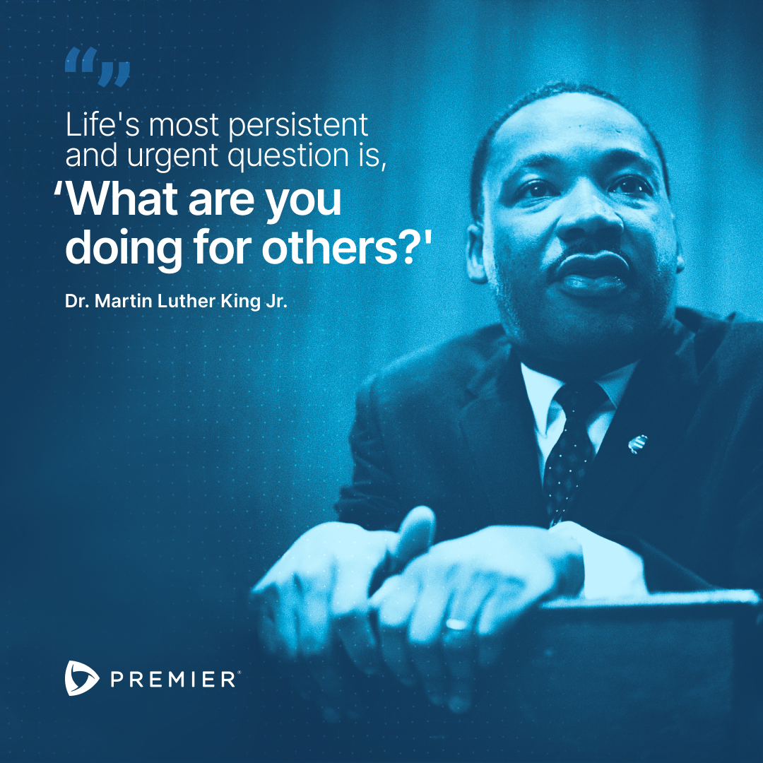A blue-tinted image of Dr. Martin Luther King Jr. with a quote about helping others, alongside the Premier logo.
