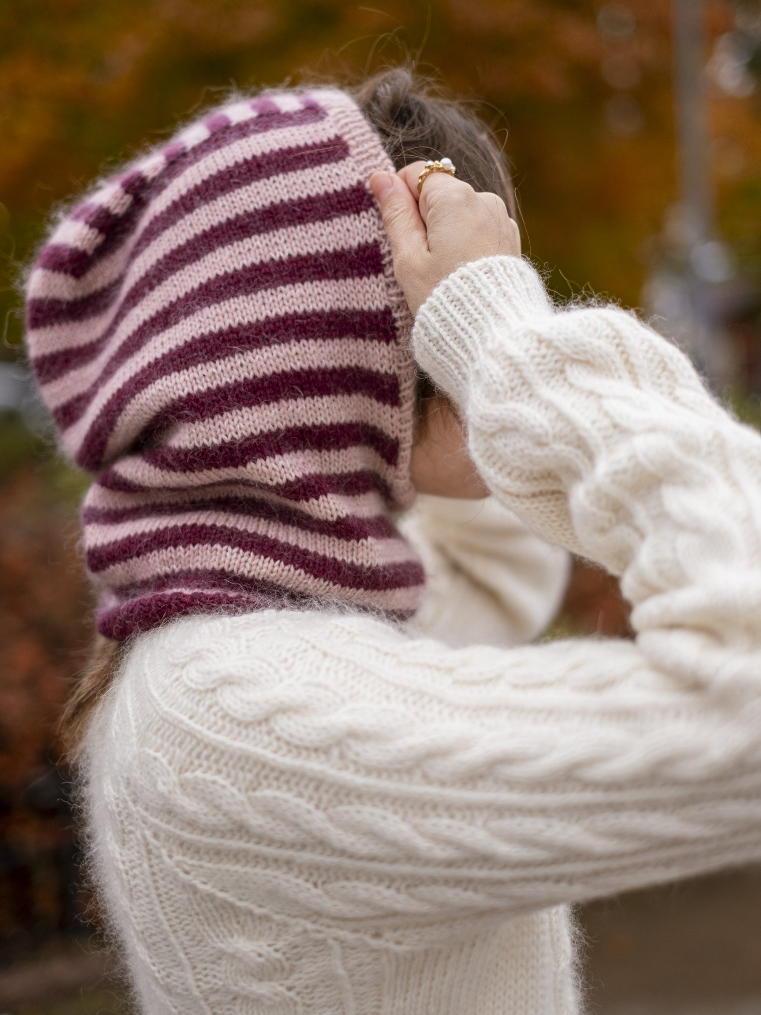 in-my-stripes-era-balaclava-pulling-on-striped-knit-hood-outdoors.jpg