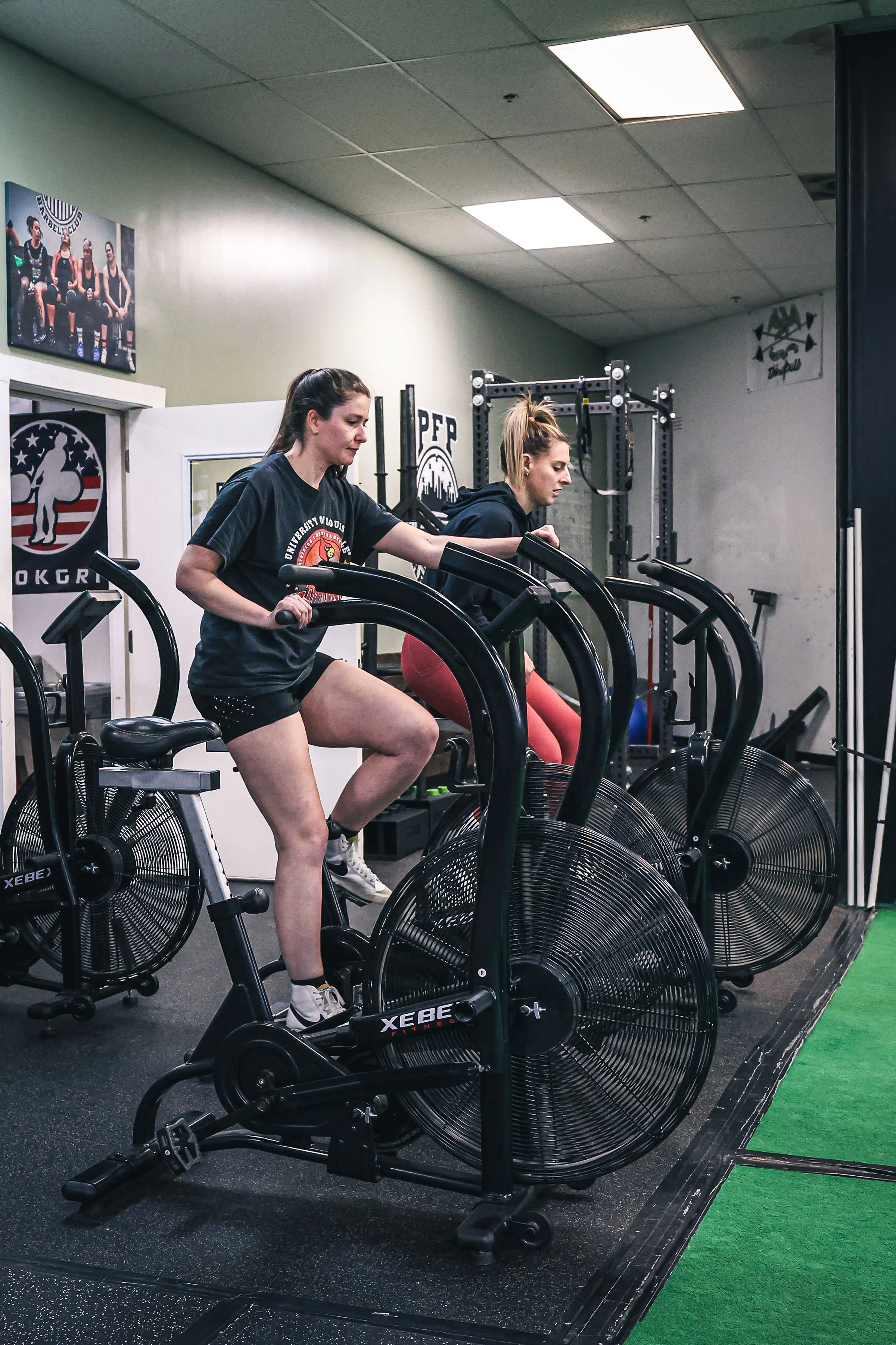 Image of a PFP Method class; client on air bikes.