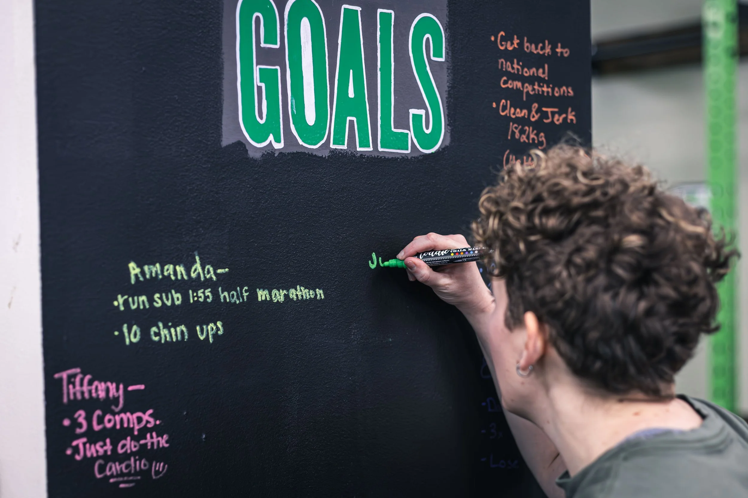 A PFP client writing her goals on the PFP accountability pillar.