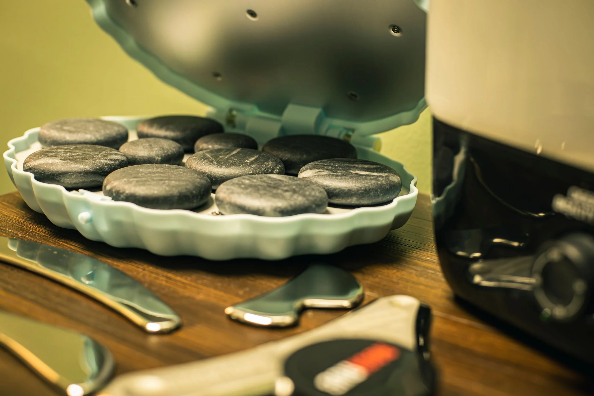 Image of massage therapy hot stones and other tools.