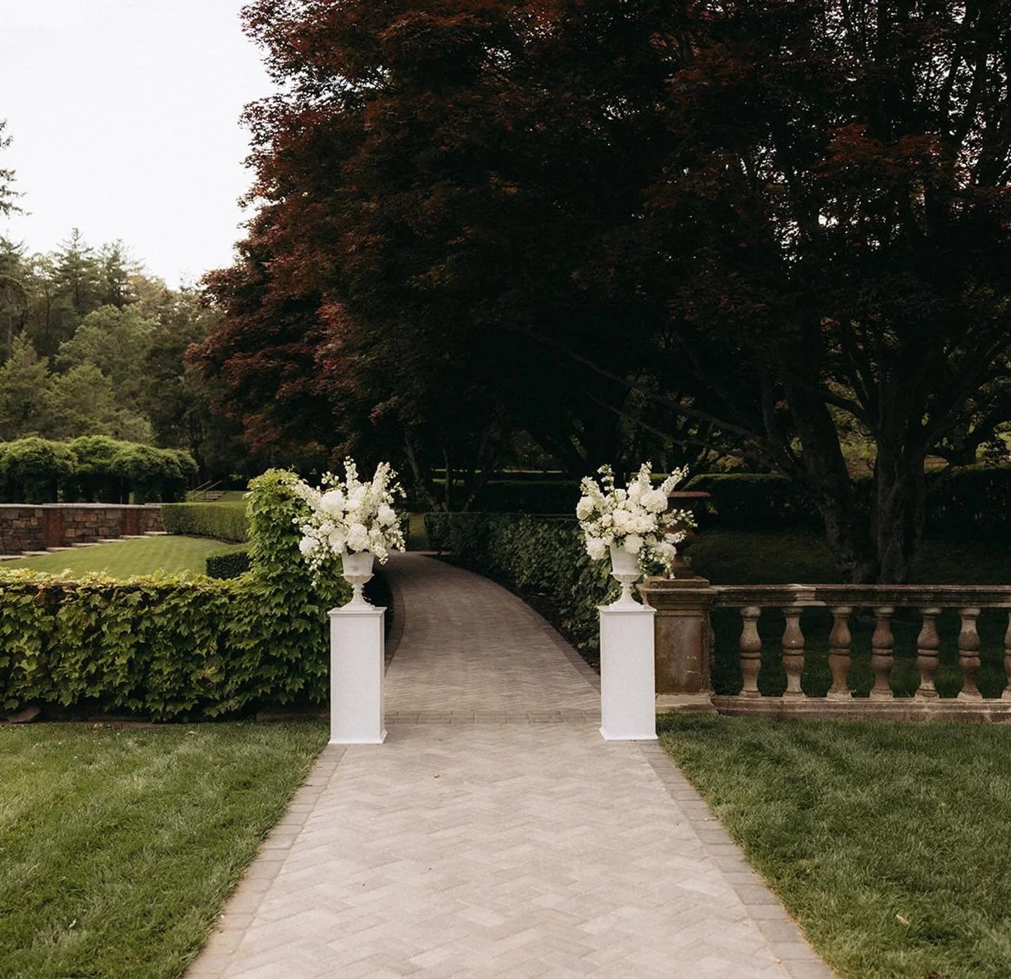 For Angela and Ben&rsquo;s June wedding at The Mansion on Turner Hill, the ethos of understated elegance guided every stem.

I had restoration carpenter Dylan Runnion craft these stunning classic pillars to flank the pathway to their ceremony. All-wh