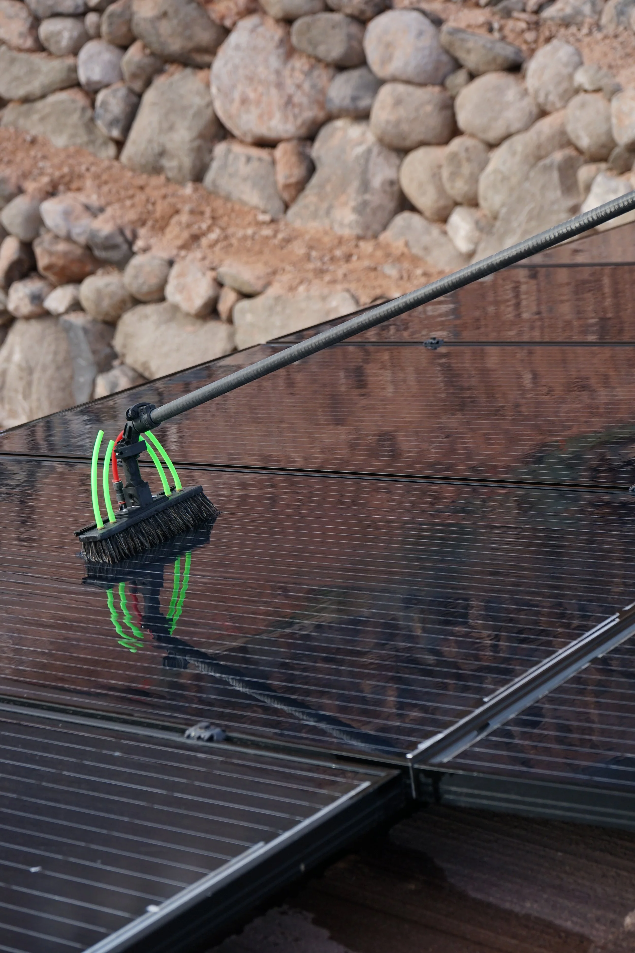 washing dirty solar panels by scrubbing all of the dirt off. 