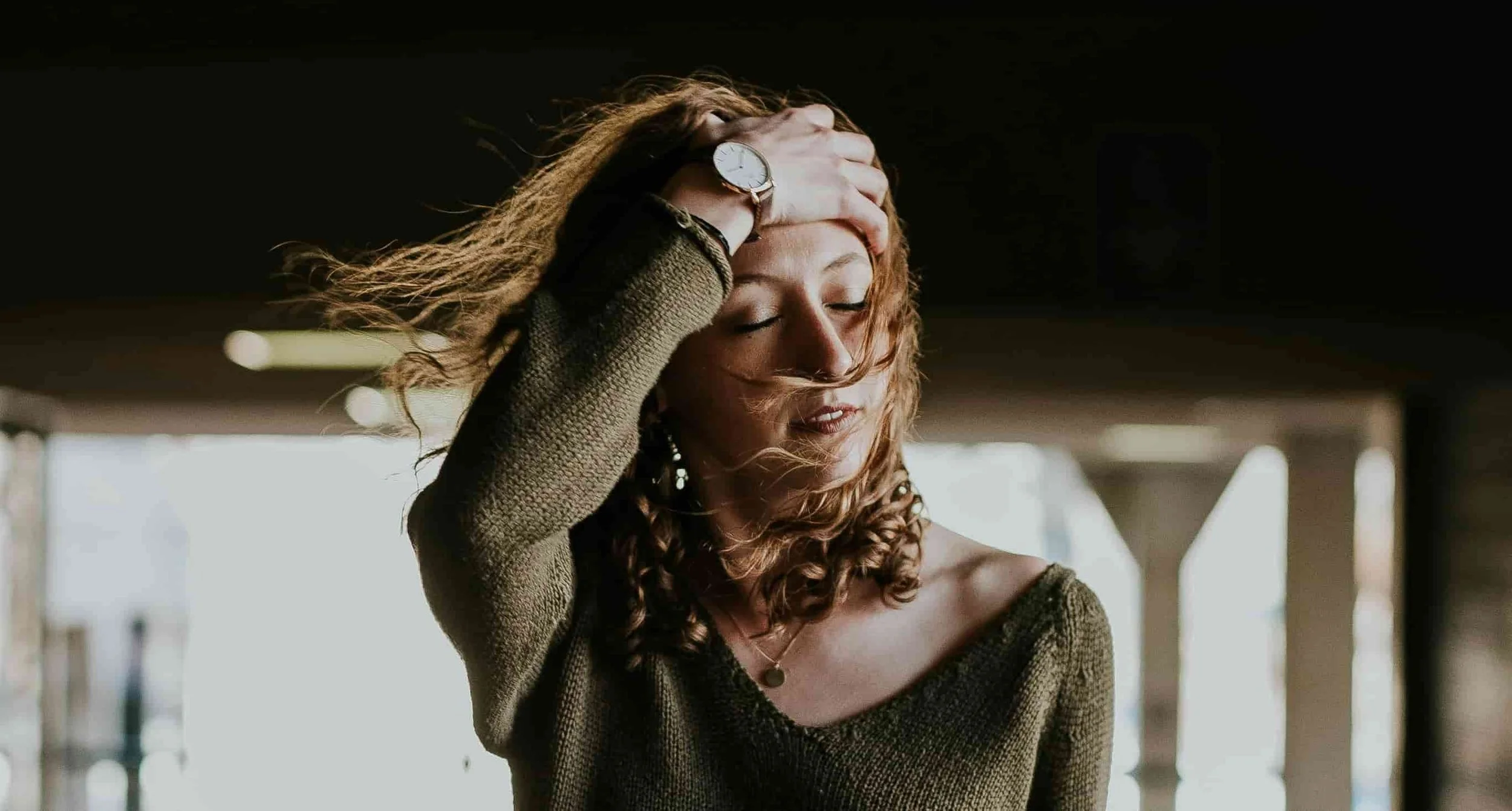 woman moving hair from face