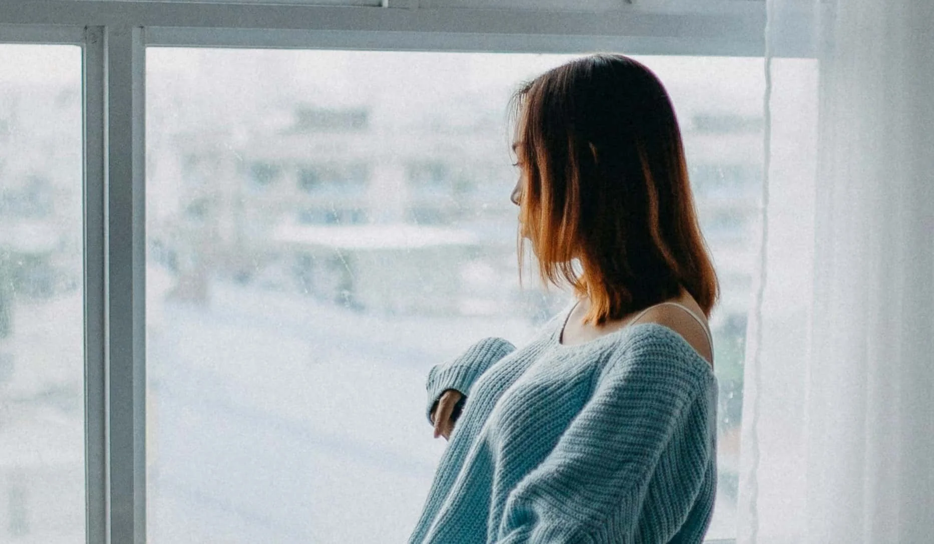 woman looking out window