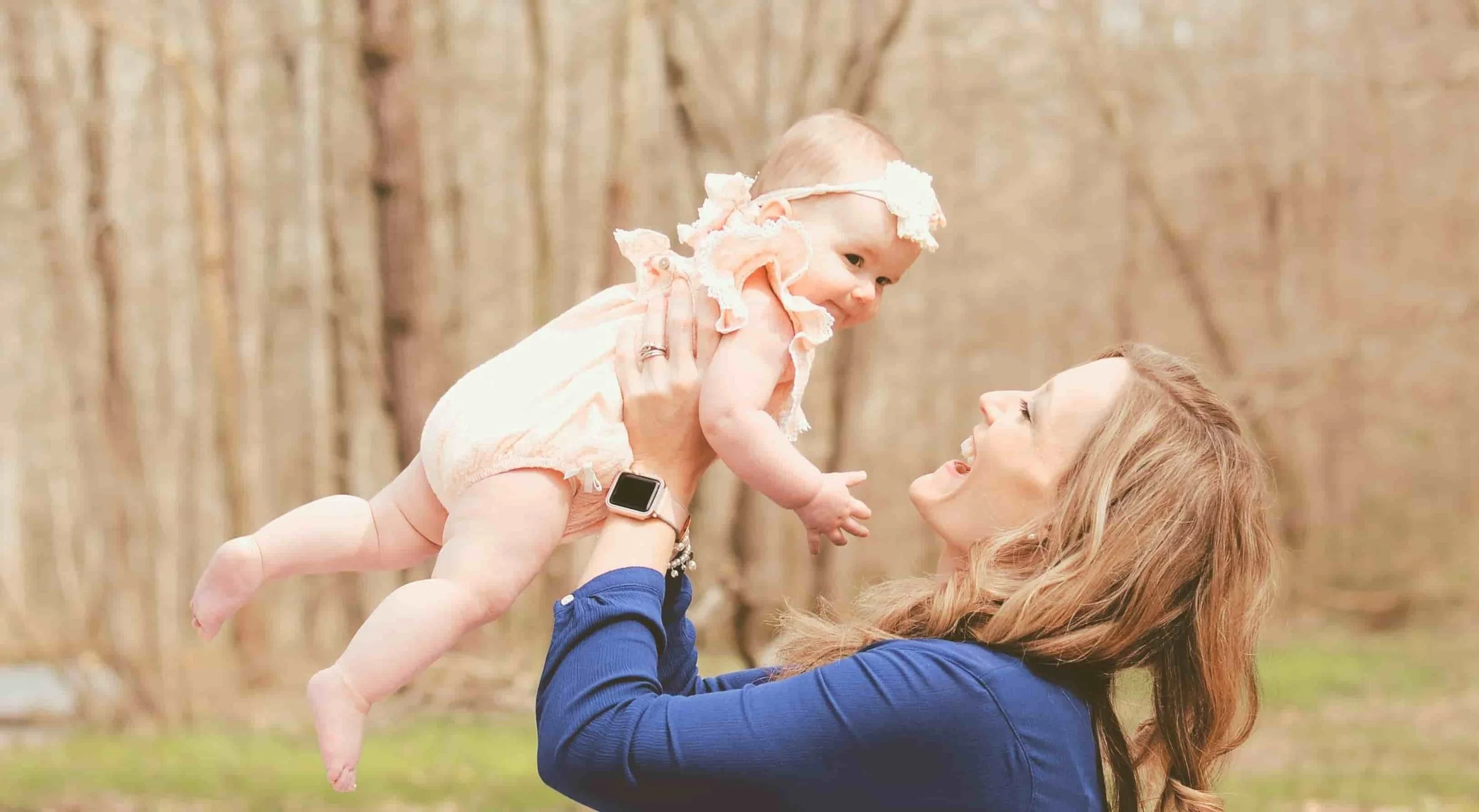 mom holding baby to the sky