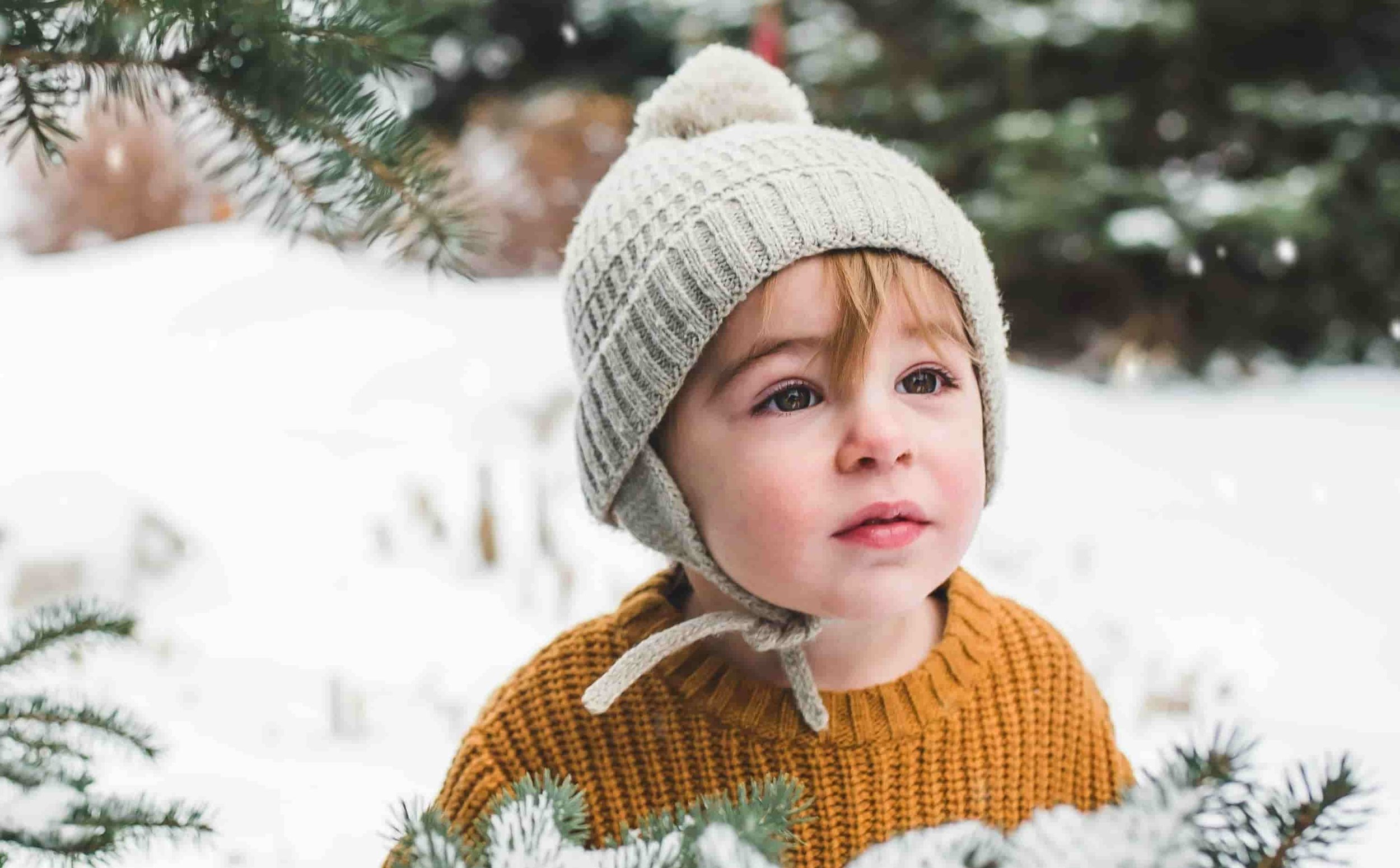 little boy playing outside in the winter