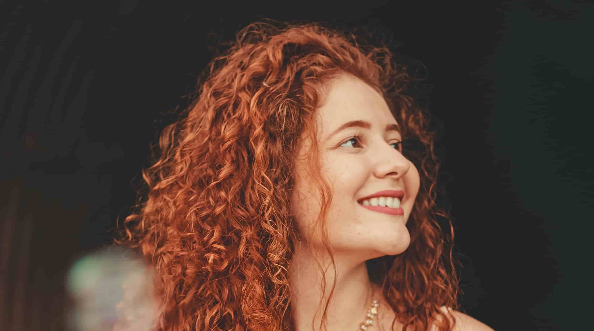 woman looking off to the side while smiling