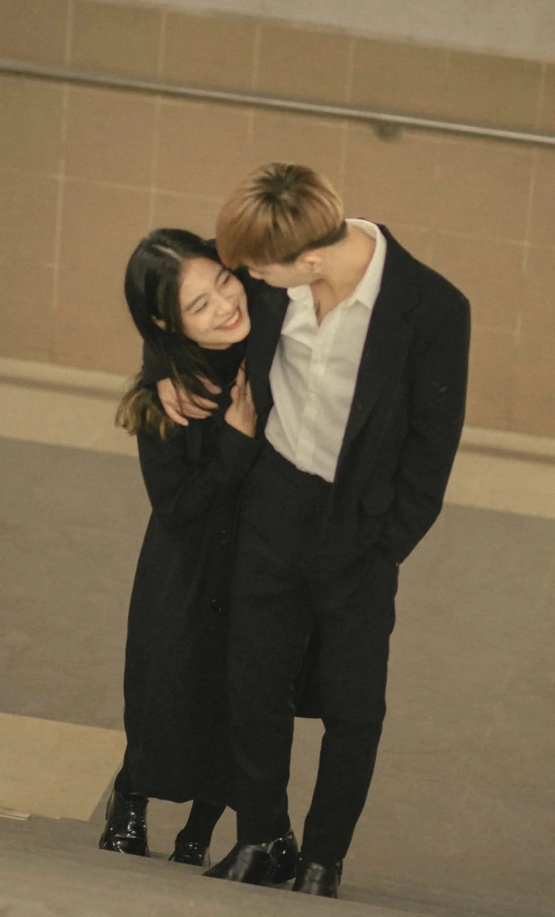 couple hugging while walking up the stairs