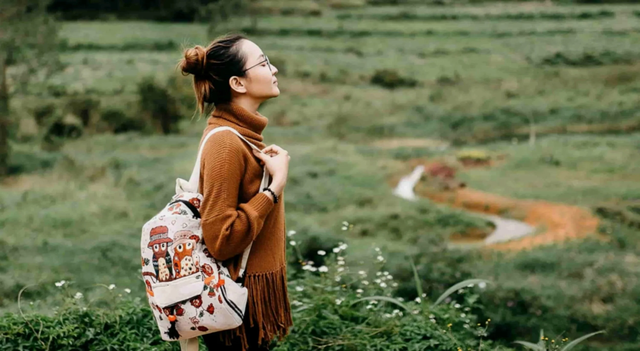 woman standing in forest enjoying nature