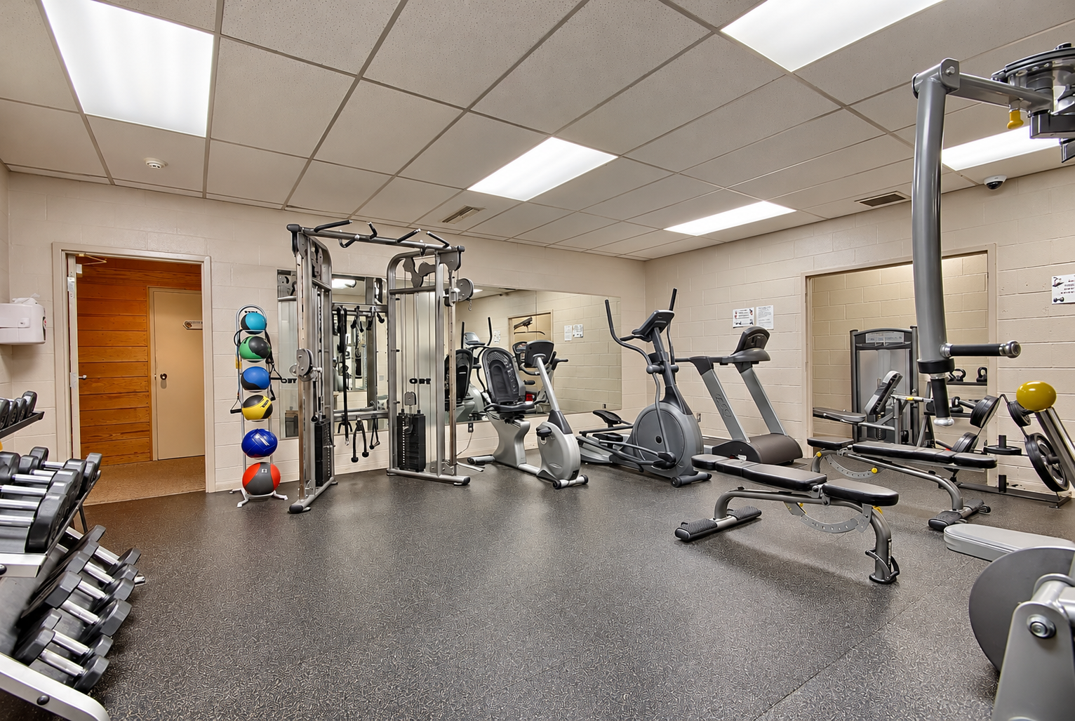 Bright, Well-Organized Empty Fitness Room.png