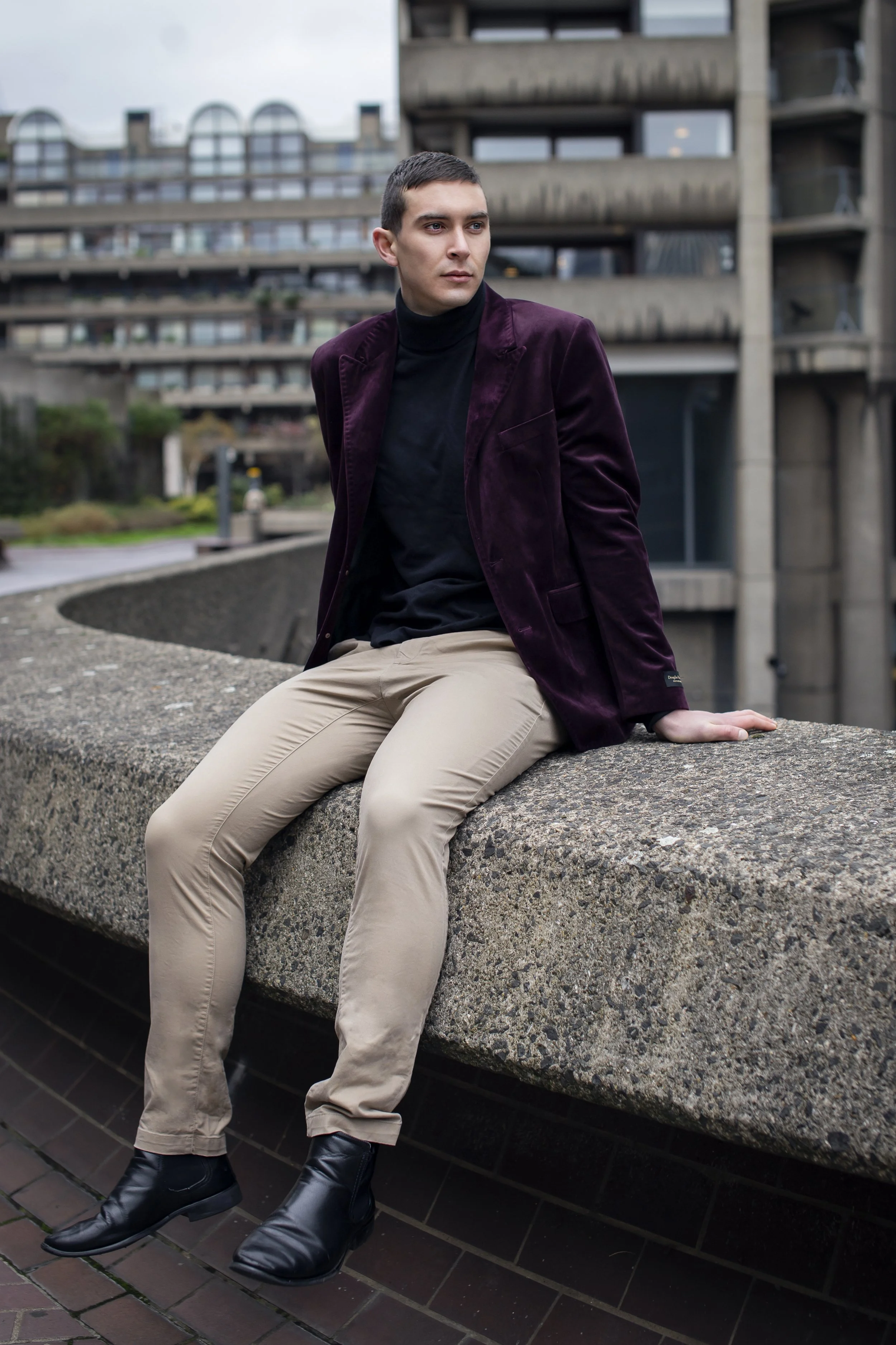 Mike Corr Circus model full body sitting down pose in smart suit photoshoot