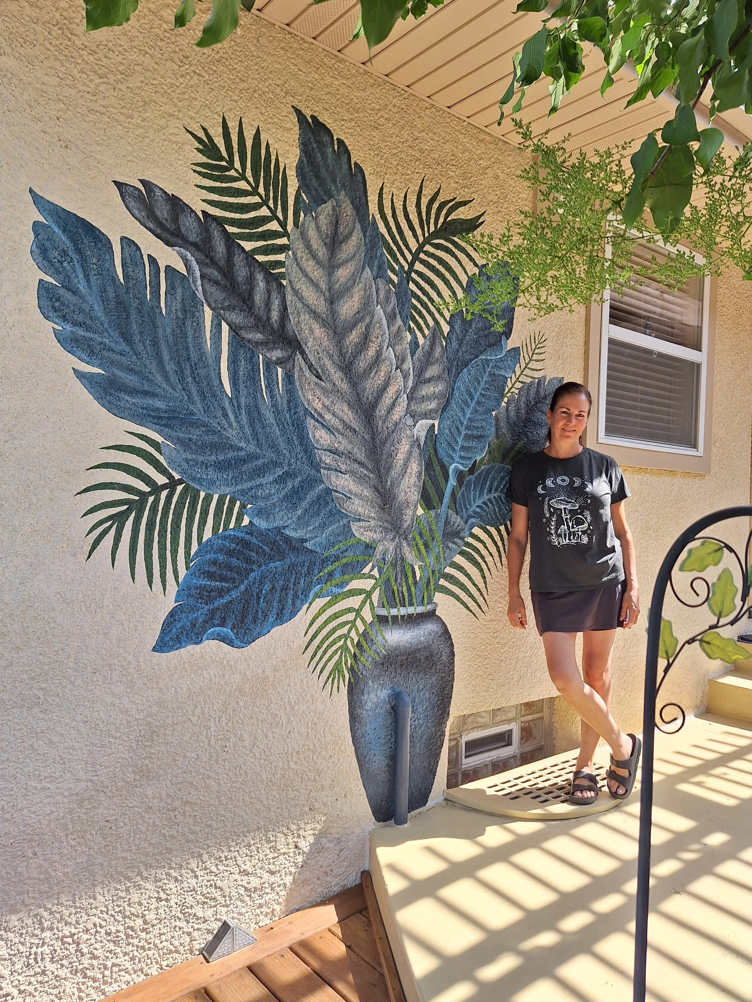 Sharma next to wall mural