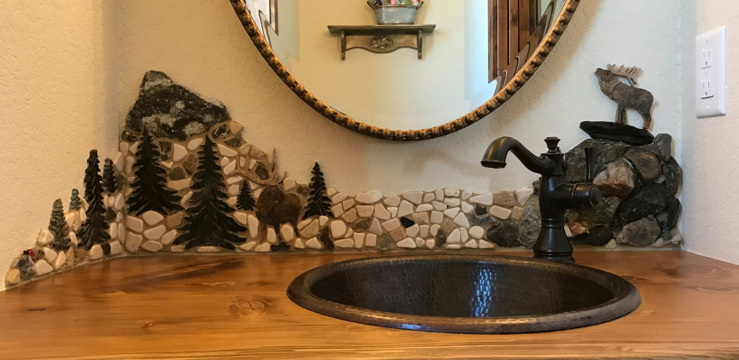 (12" x 46" total) Elk themed powder room, an old bull Elk on ledge bugles a challenge to the young interloper below. The scene is composed of stones and gems to give this distinctive artwork a natural feel, and it’s sealed and caulked to protect the
