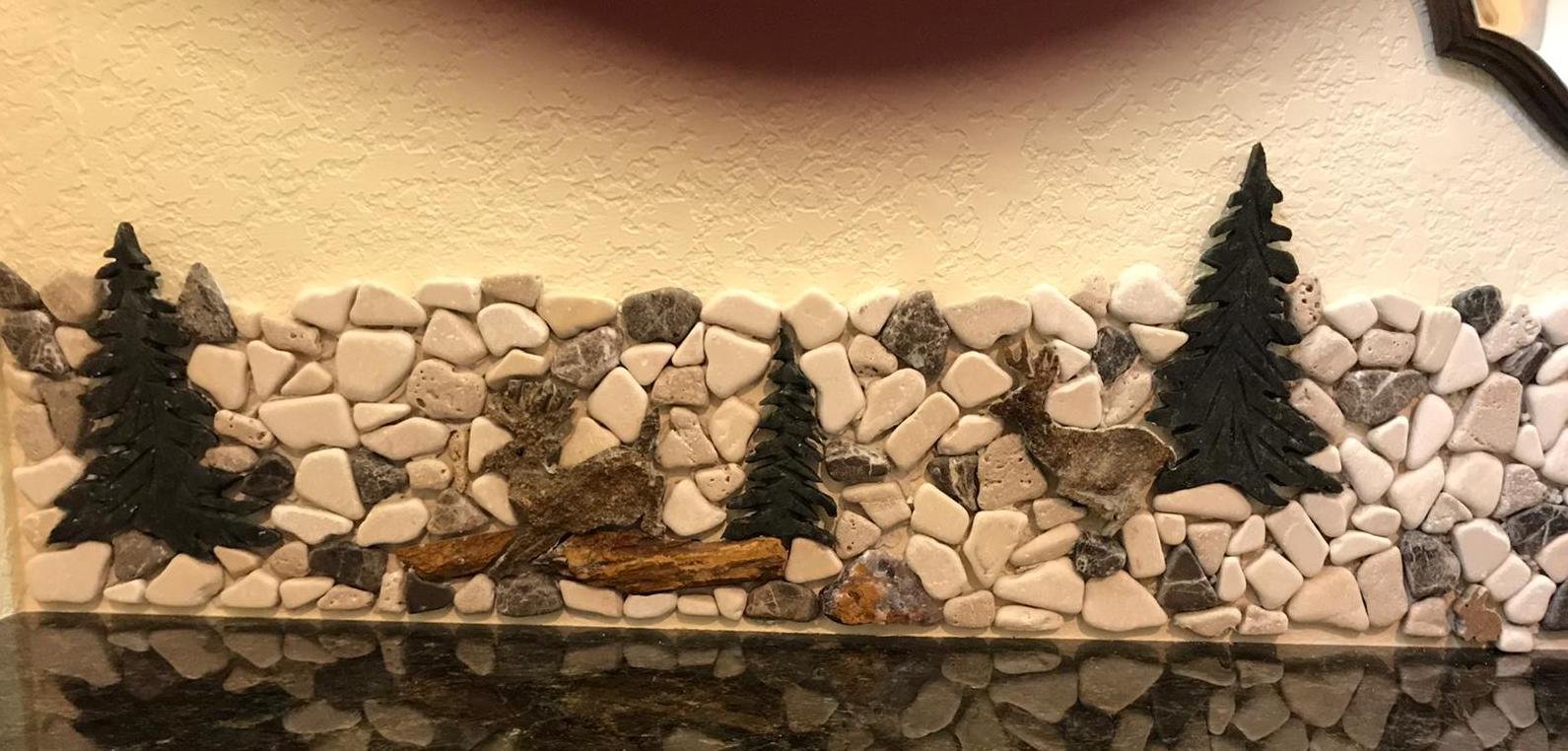 Far left side has a sandstone elk jumping over a petrified wood log, with a young buck running behind him.
Petrified wood gives great grounding and patience energy, and the Amethystine boulder to right of log offers the protection and peace.
The tr
