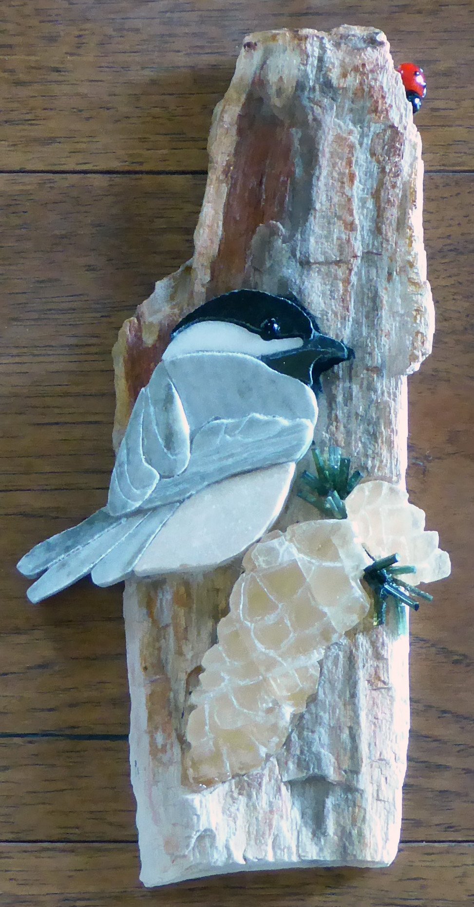 SOLD: Chickadee on Pinecones. This darling 3D Chickadee perched on pinecones is made entirely from natural stones, minerals, and petrified wood.
In the Opus Sectile mosaic tradition, each chickadee marble, granite and slate piece was cut and fit t